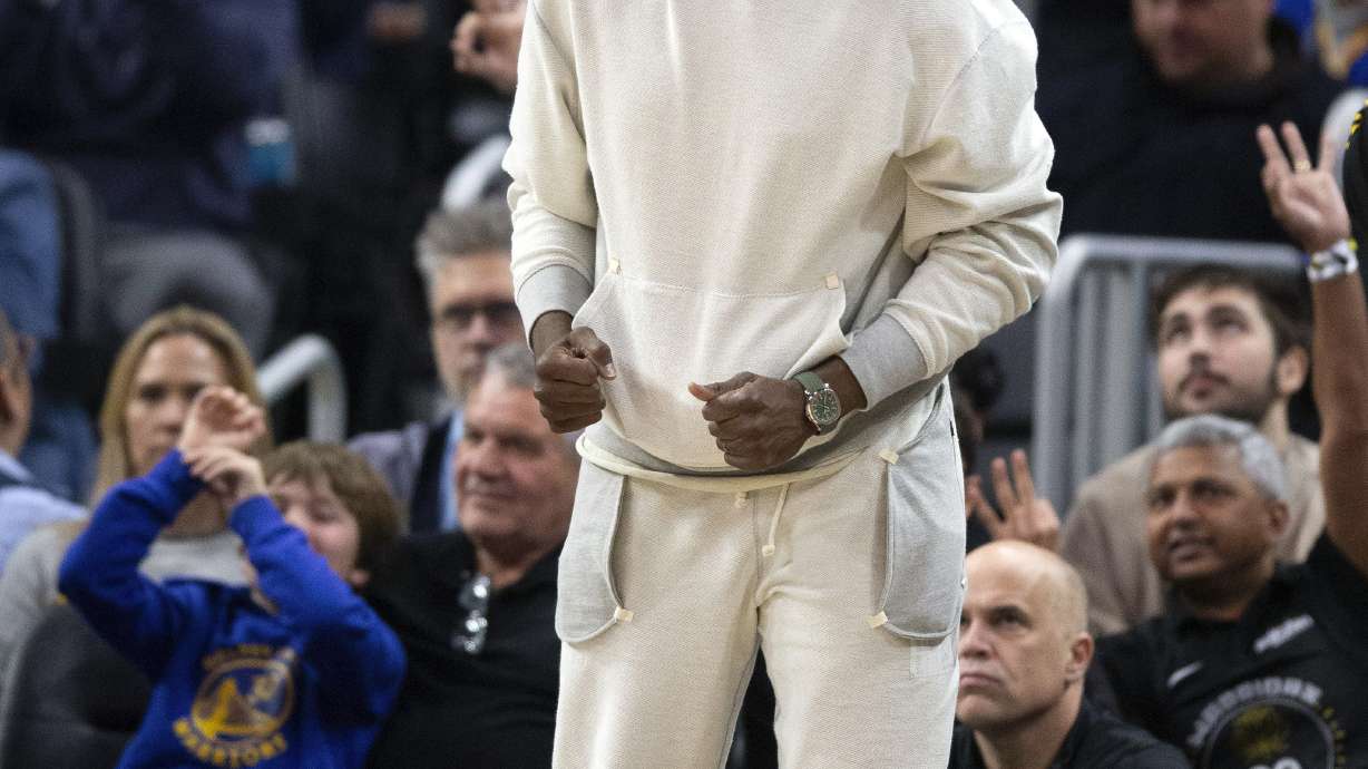Golden State Warriors forward Draymond Green, center, reacts to his team's play against the Toronto Raptors during the third quarter of an NBA basketball game, Sunday, Jan. 7, 2024, in San Francisco. Although Green has been reinstated from his suspension, he did not play in Sunday's game.
