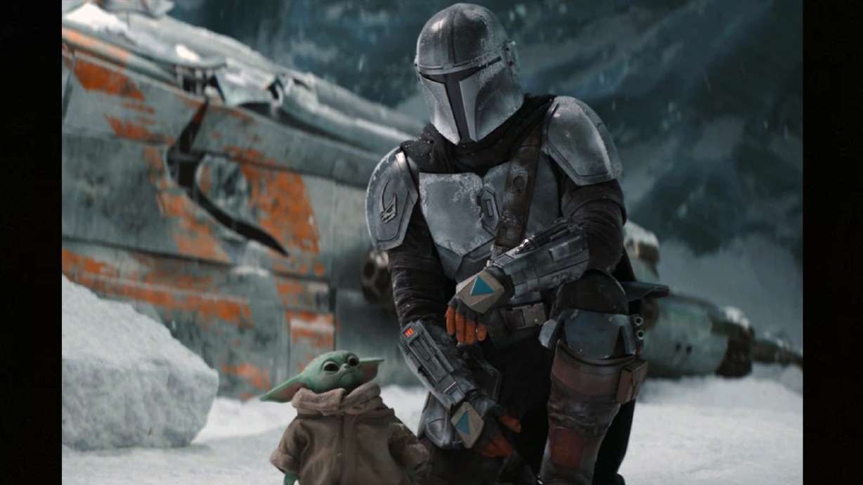 This image released by Disney+ shows Pedro Pascal in a scene from “The Mandalorian.” Jon Favreau is set to direct the film “The Mandalorian & Grogu” which will go into production this year, Lucasfilm and Disney announced Tuesday.