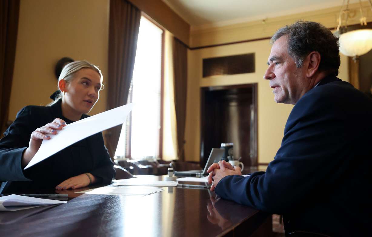 Brooke Taylor, elections coordinator for the Office of the Lieutenant Governor, helps former House Minority Leader Brian King file to run for governor at the Capitol in Salt Lake City, on Jan. 3.