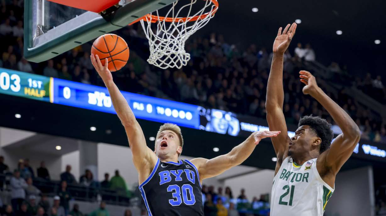 BYU guard Dallin Hall (30) scores against Baylor center Yves Missi (21) during the first half of an NCAA college basketball game Tuesday, Jan. 9, 2024, in Waco, Texas.