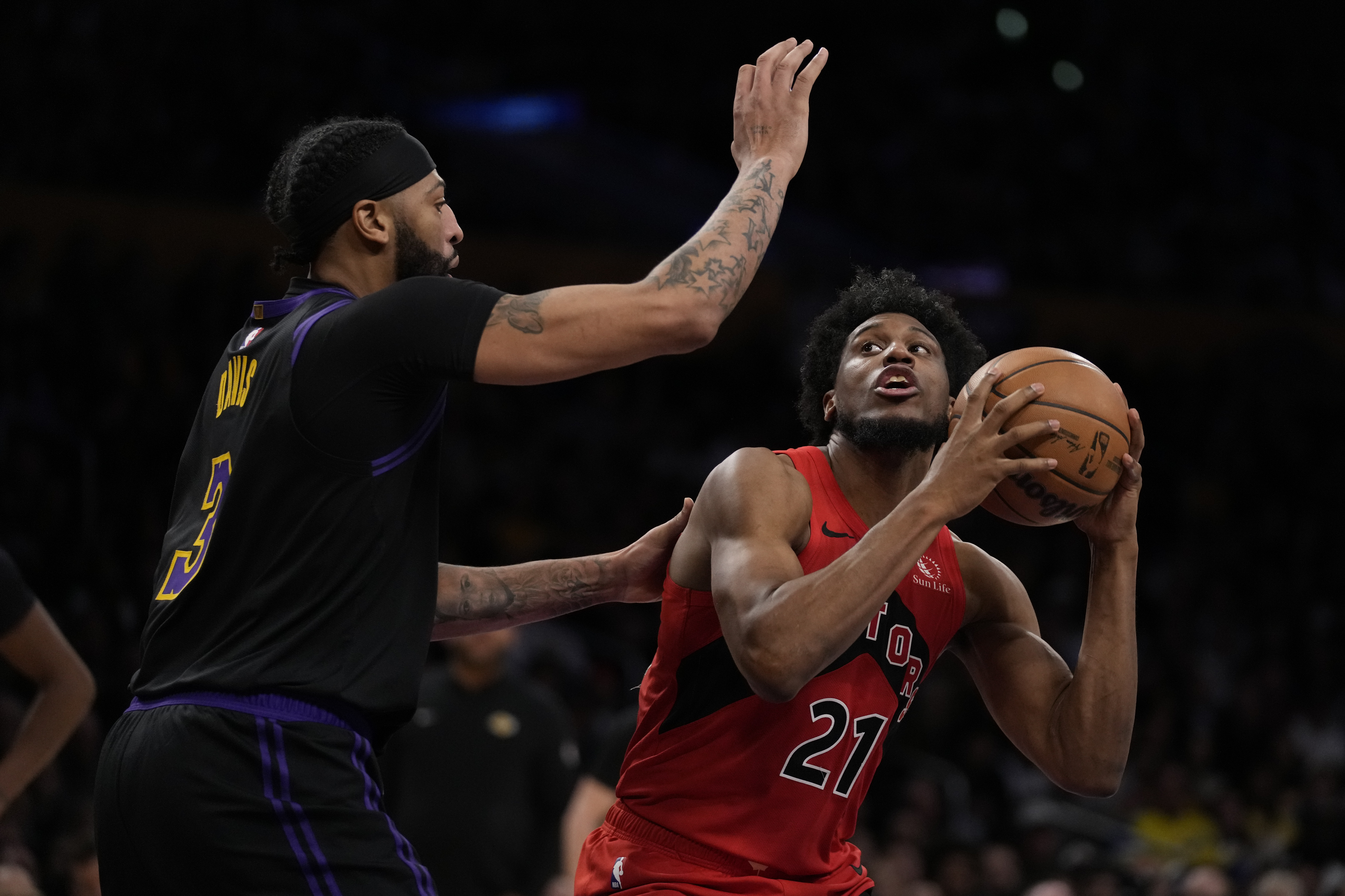 Los Angeles Lakers forward Anthony Davis (3) defends against Toronto Raptors forward Thaddeus Young (21) during the first half of an NBA basketball game in Los Angeles, Tuesday, Jan. 9, 2024. 