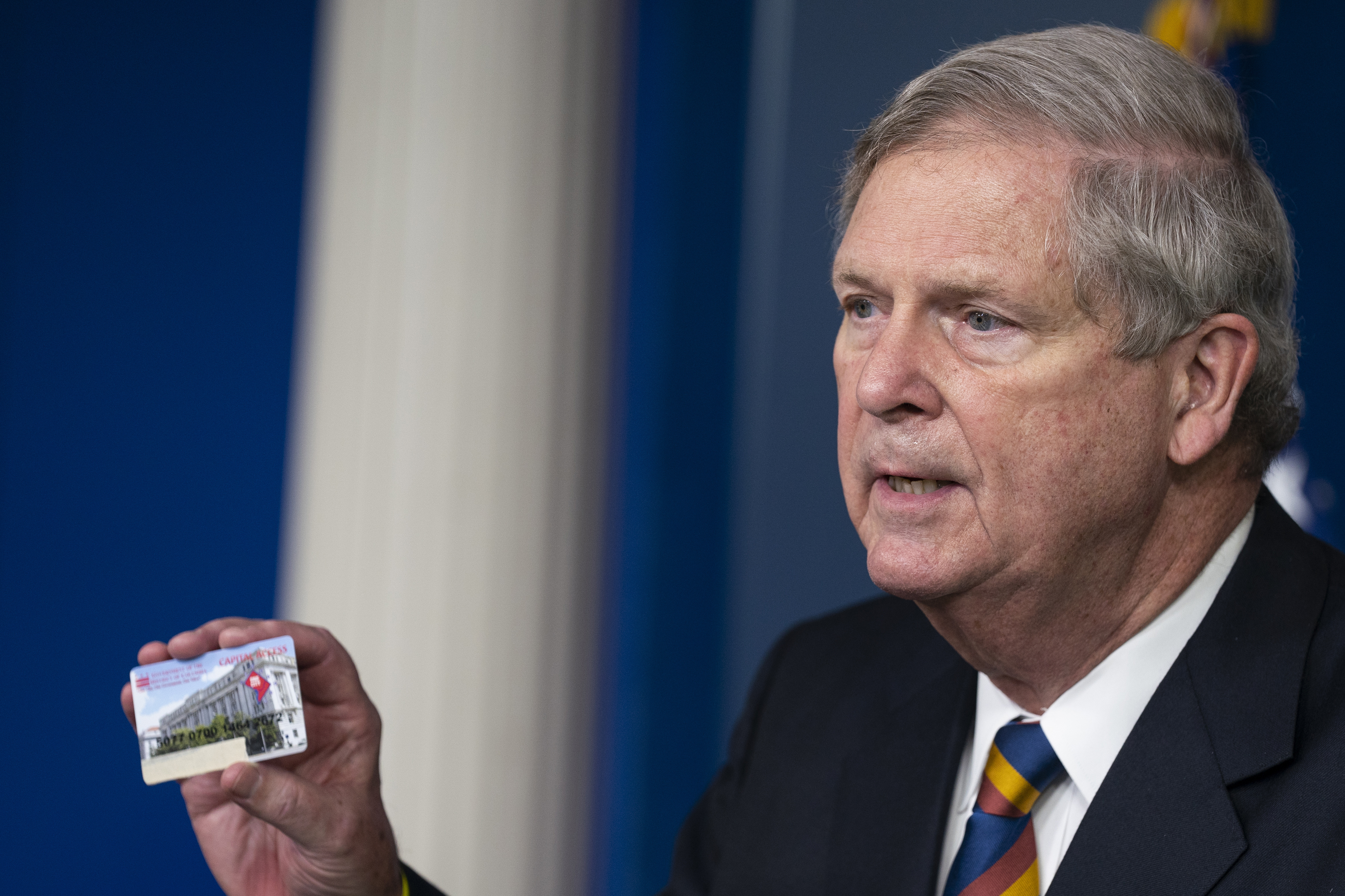 Agriculture Secretary Tom Vilsack holds up a Supplemental Nutrition Assistance Program Electronic Benefits Transfer card during a news conference at the White House, May 5, 2021, in Washington.