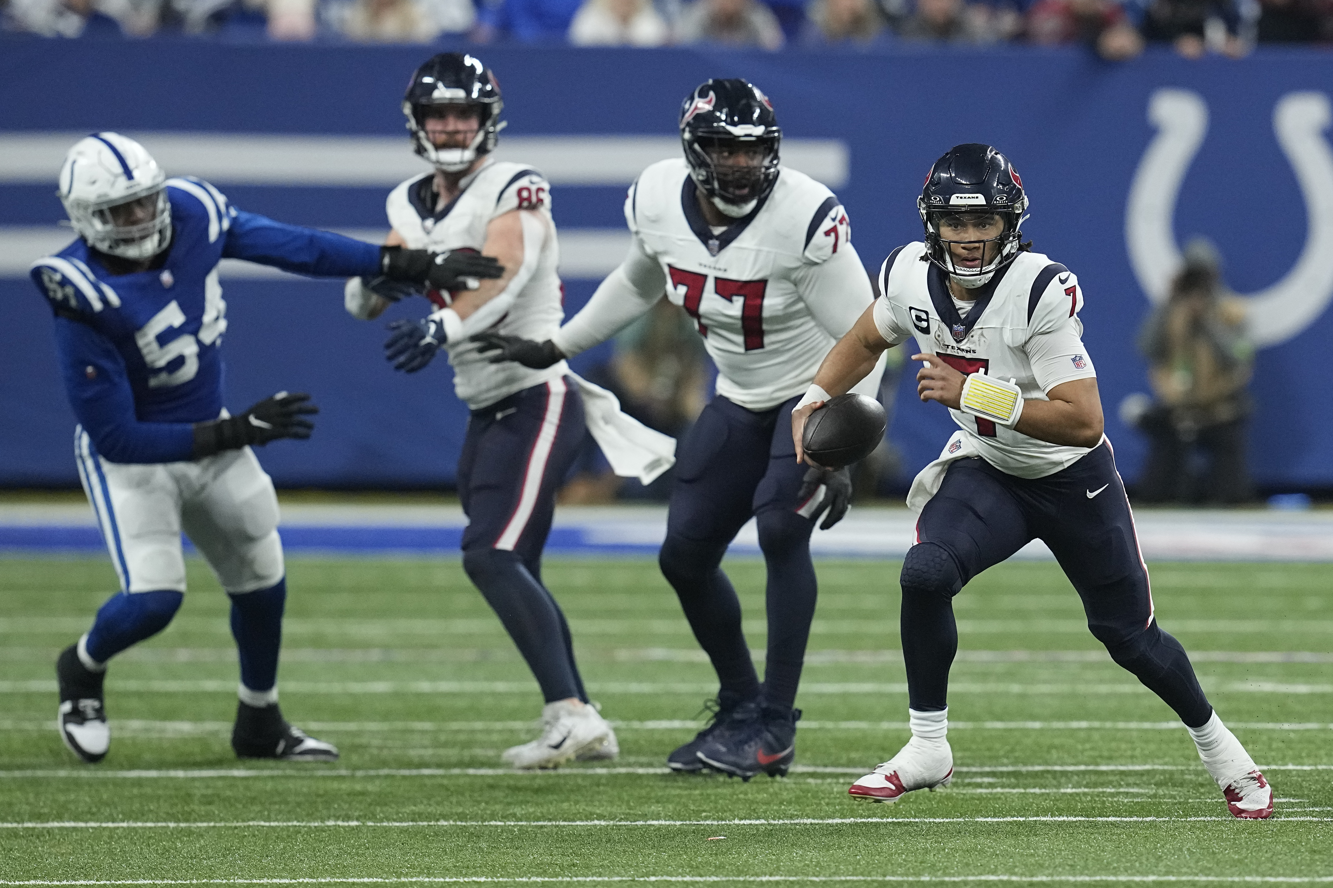 Houston Texans quarterback C.J. Stroud, right, runs during the second half of an NFL football game against the Indianapolis Colts, Saturday, Jan. 6, 2024, in Indianapolis. 