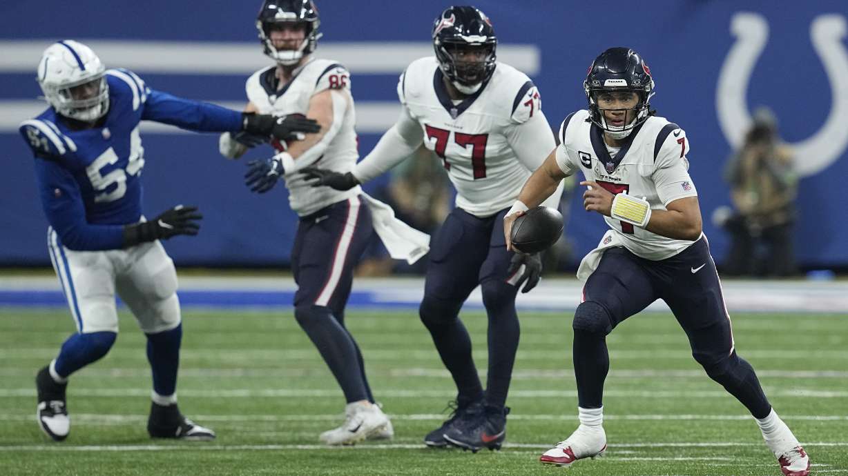 Houston Texans quarterback C.J. Stroud, right, runs during the second half of an NFL football game against the Indianapolis Colts, Saturday, Jan. 6, 2024, in Indianapolis.