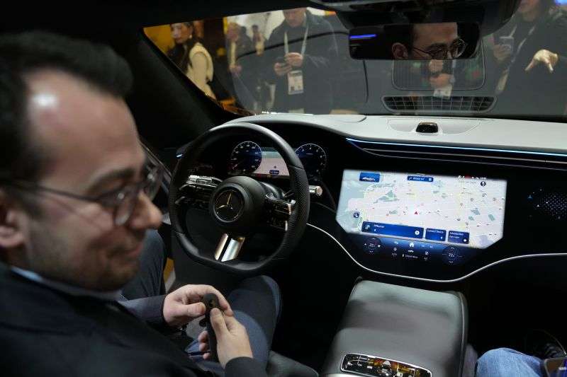 Vadim Weiss, Mercedes-Benz USA, gives a demonstration of the company's car operating system, MBOS, during the CES tech show Tuesday, in Las Vegas.