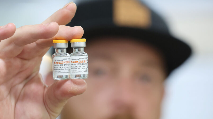 Riley Drage, a Utah Naloxone trainer, holds a naloxone vial prior to training for opioid overdose in Salt Lake City on May 23, 2023.
