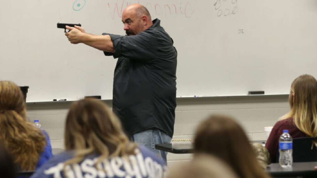 Justin Mortensen shows teachers how to stand when firing a gun at the Utah County Sheriff's Office in Spanish Fork on June 12, 2019. Lawmakers may get a chance to vote on a bill to provide incentives for teachers willing to carry a firearm in school.