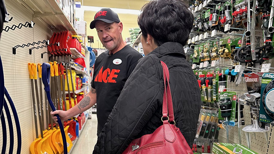 John Harris speaks to a customer about which snow removal equipment she should use.