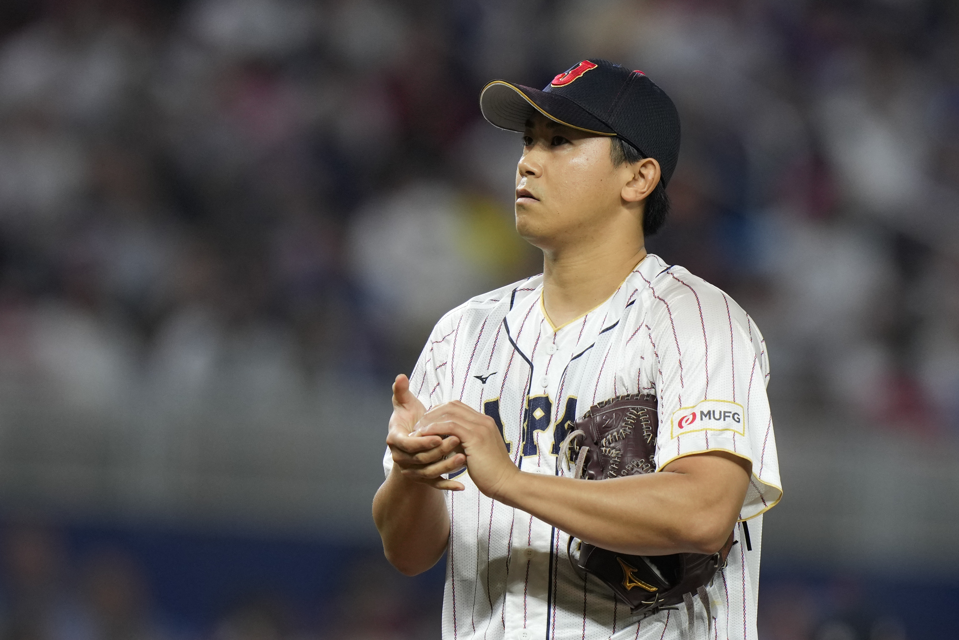 FILE - Japan pitcher Shota Imanaga (21) prepares to throw during the first inning of a World Baseball Classic championship game against the United States, Tuesday, March 21, 2023, in Miami. Imanaga and the Chicago Cubs finalized a $53 million, four-year contract on Thursday, Jan. 11, 2024, a deal that includes a club option that could make the agreement worth $80 million over five seasons.