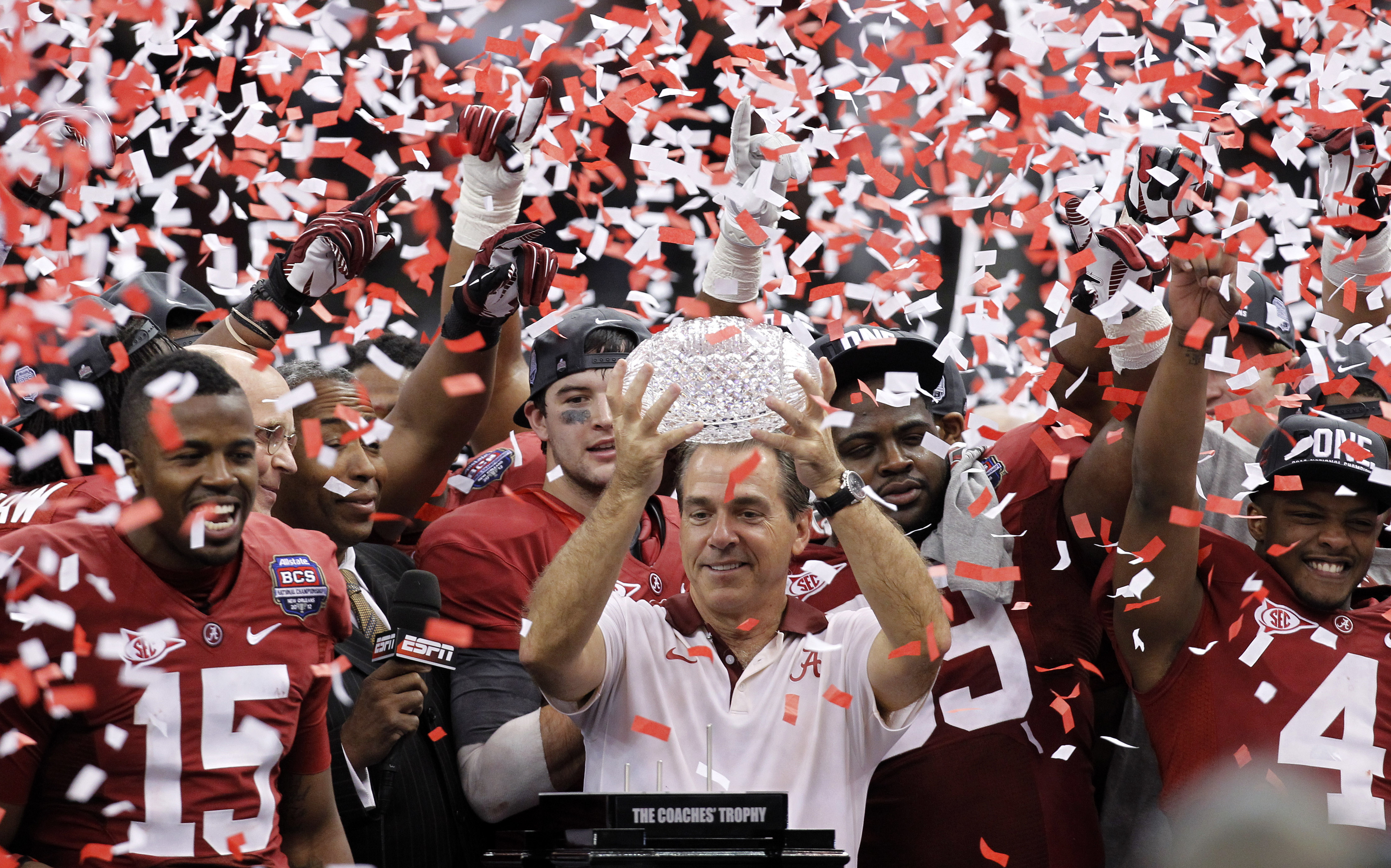 FILE - Alabama head coach Nick Saban celebrates with his team after the BCS National Championship college football game against LSU, Jan. 9, 2012, in New Orleans. Nick Saban, the stern coach who won seven national championships and turned Alabama back into a national powerhouse that included six of those titles in just 17 seasons, is retiring, according to multiple reports, Wednesday, Jan. 10, 2024. 