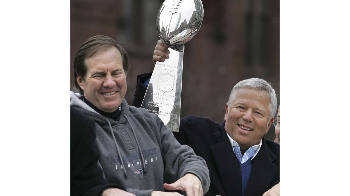 FILE - New England Patriots head coach Bill Belichick, left, smiles as team owner Robert Kraft holds up the Vince Lombardi trophy during a Super Bowl victory parade in Boston, Tuesday, Feb . 8, 2005. The Patriots beat the Philadelphia Eagles 24-21 in Super Bowl XXXIX. Six-time NFL champion Bill Belichick has agreed to part ways as the coach of the New England Patriots on Thursday, Jan. 11, 2024, bringing an end to his 24-year tenure as the architect of the most decorated dynasty of the league’s Super Bowl era, a source told the Associated Press on the condition of anonymity because it has not yet been announced.