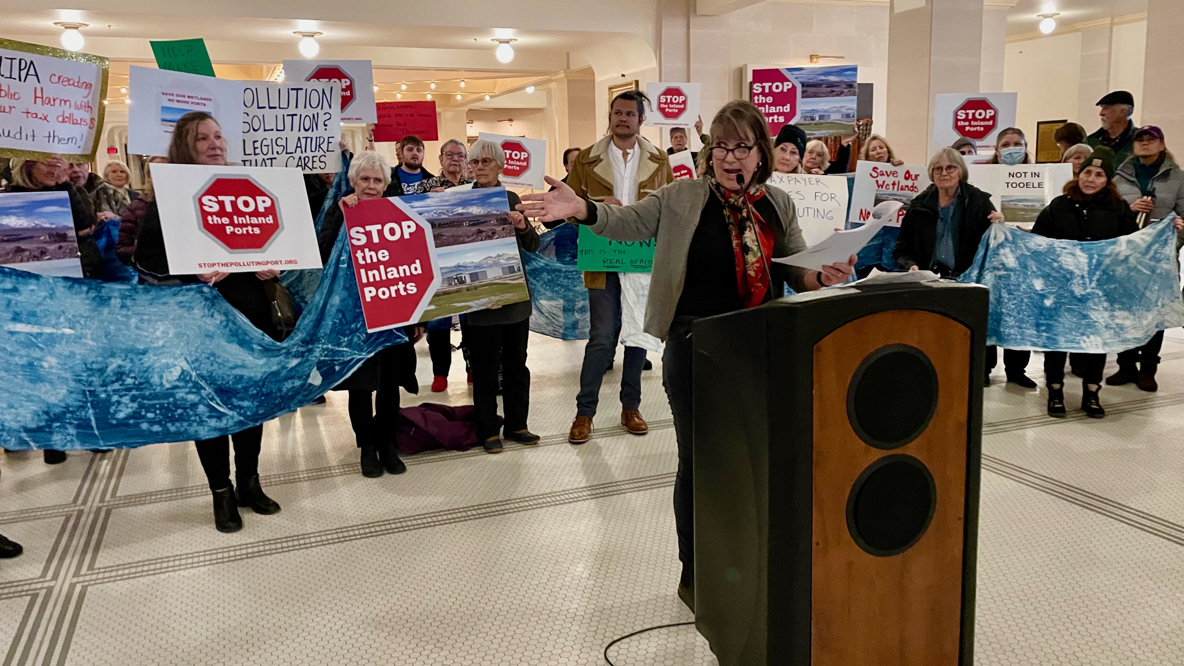 Deeda Seed, at the podium, and other critics of Utah Inland Port Authority initiatives demonstrated Wednesday at the Utah Capitol in Salt Lake City. Seed and the other critics seek a full audit of inland port operations, but the group's head says it already faces plenty of scrutiny.