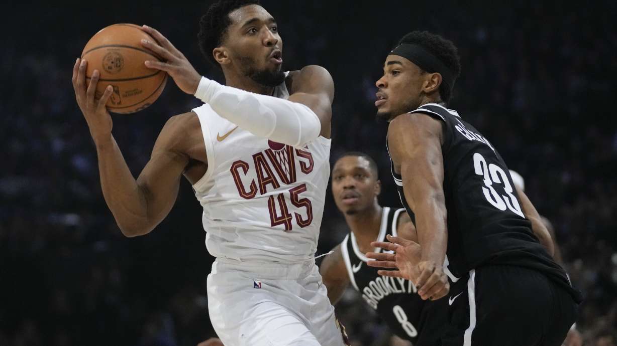 Cleveland Cavaliers' Donovan Mitchell, left, drives to the basket during the NBA basketball game between Brooklyn Nets and Cleveland Cavaliers, at the Accor Arena in Paris, Thursday, Jan. 11, 2024.