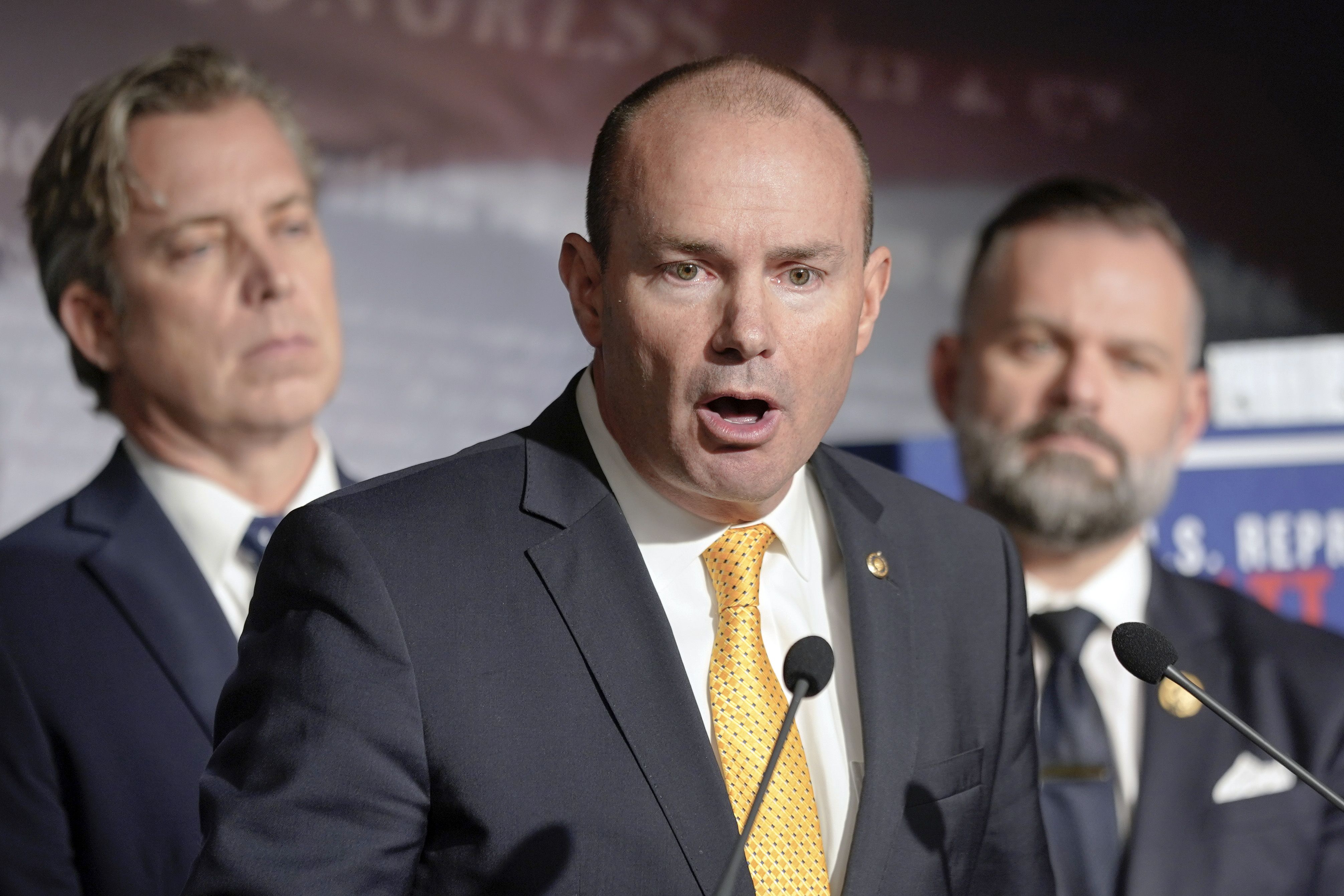 Sen. Mike Lee, R-Utah, center, speaks during a news conference on border security and funding on Capitol Hill on Wednesday, as Rep. Cory Mills, R-Fla., right, and Rep. Andrew Ogles, R-Tenn., left, listen in Washington.