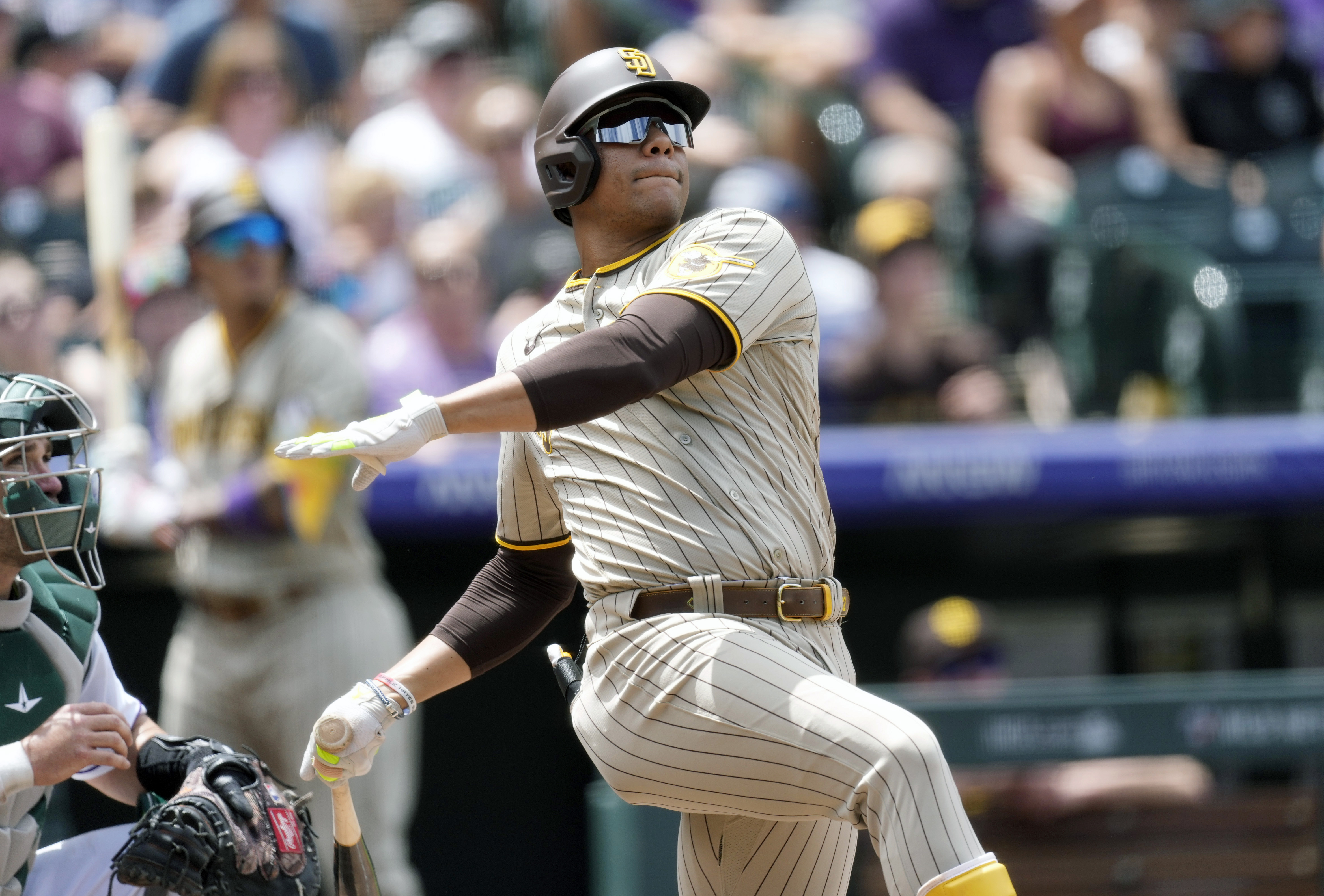 FILE - San Diego Padres' Juan Soto follows the flight of his two-run home run against Colorado Rockies starting pitcher Kyle Freeland in the third inning of a baseball game, Wednesday, Aug. 2, 2023, in Denver. Juan Soto, Vladimir Guerrero Jr. and Pete Alonso are among 194 players across Major League Baseball still negotiating salaries for the 2024 season leading into Thursday’s Jan. 11, 2024, deadline.