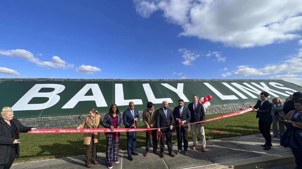 In this photo provided by the Office of the Mayor of New York, Mayor Eric Adams, third left, participates in the ribbon cutting ceremony and sign unveiling of Bally Links, formerly Trump Links, at Ferry Point in the Bronx borough of New York, Thursday, Jan. 11, 2024.
