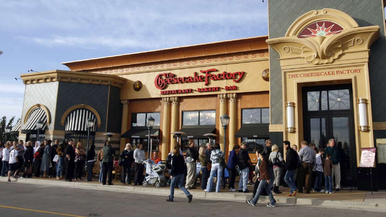 Patrons line up outside the Cheesecake Factory in Murray as the restaurant opens its doors for business Thursday, Nov. 1, 2007. Why are so many willing to wait in line for hours when a new store opens?