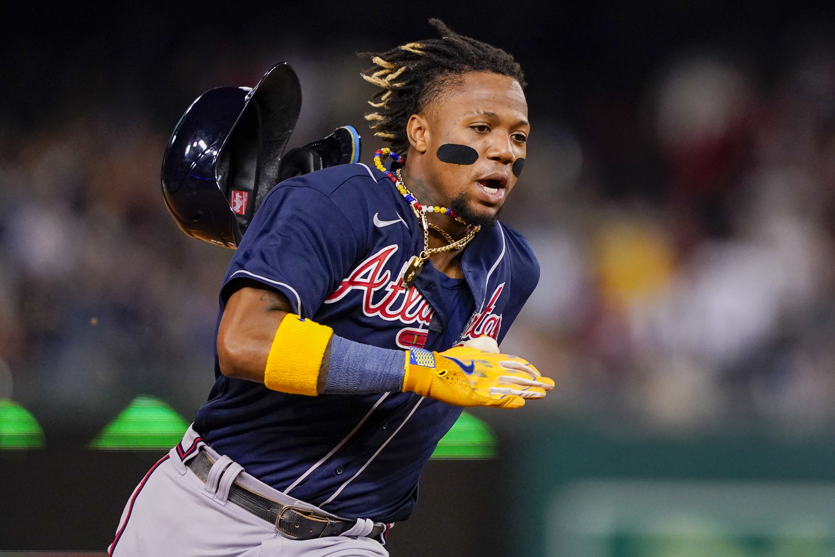FILE - Atlanta Braves' Ronald Acuña Jr. runs to third base on a double by Ozzie Albies during the fifth inning of the team's baseball game against the Washington Nationals, Sept. 22, 2023, in Washington. Shohei Ohtani and Acuña won the 2023 Hank Aaron Awards on Saturday, Dec. 16, presented by Major League Baseball to the most outstanding offensive performer in each league. The MLB award is picked by fan balloting combined with votes from a panel of Hall of Famers and former winners. 