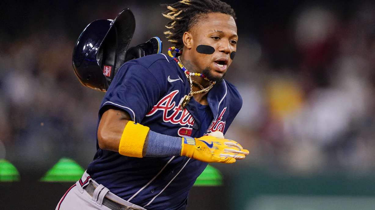 FILE - Atlanta Braves' Ronald Acuña Jr. runs to third base on a double by Ozzie Albies during the fifth inning of the team's baseball game against the Washington Nationals, Sept. 22, 2023, in Washington. Shohei Ohtani and Acuña won the 2023 Hank Aaron Awards on Saturday, Dec. 16, presented by Major League Baseball to the most outstanding offensive performer in each league. The MLB award is picked by fan balloting combined with votes from a panel of Hall of Famers and former winners.