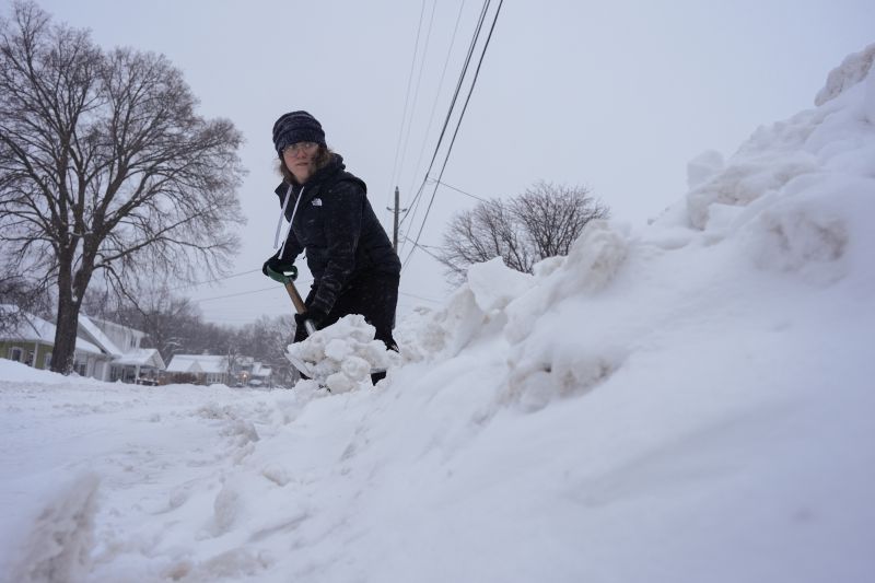Graphic designer Emily Brewer shovels out her driveway in order to drive to work in Sioux City, Iowa, early on Friday.