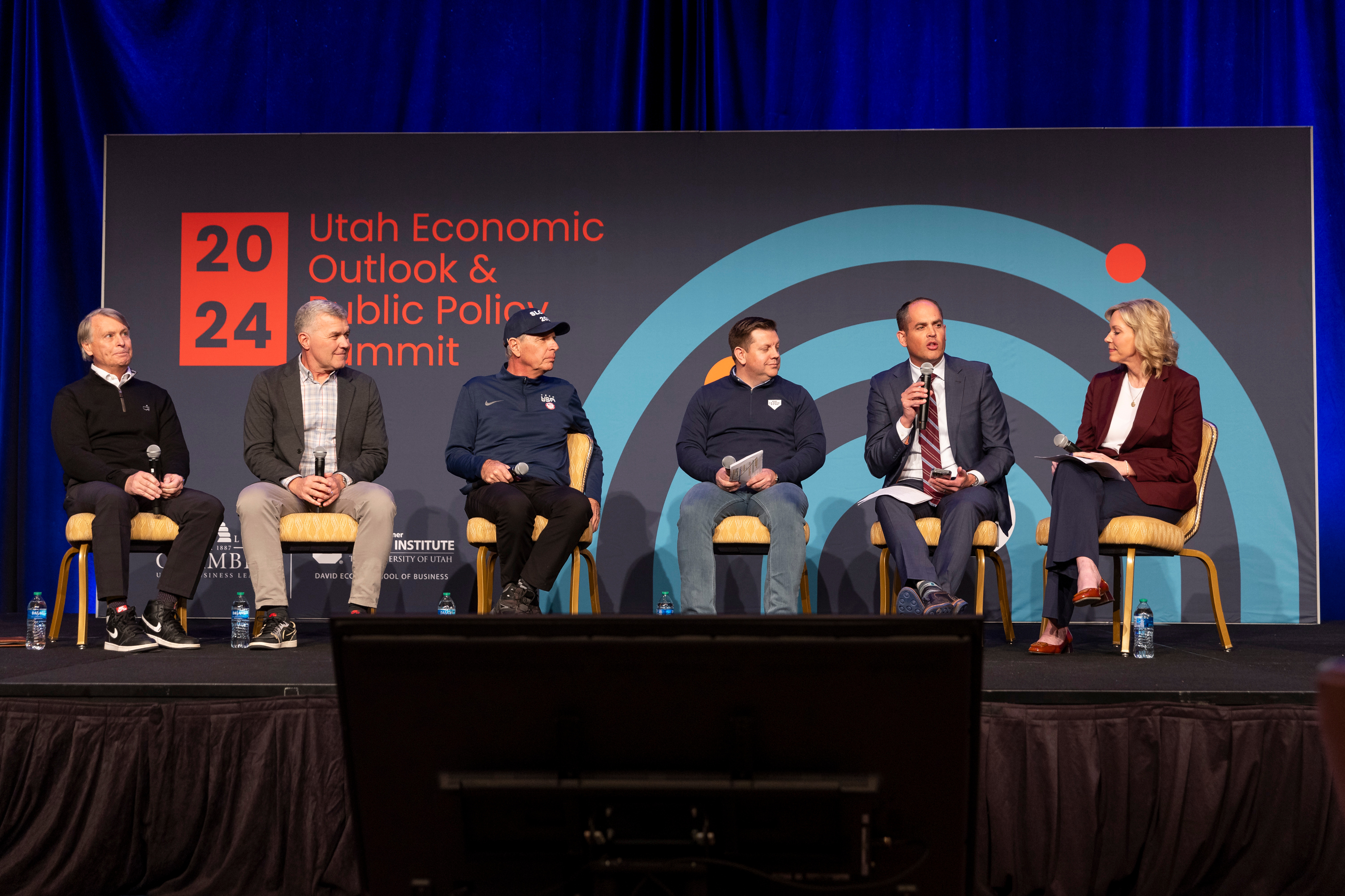 Jeff Robbins, left, president and CEO of Utah Sports Commission, Jim Olson, president of Utah Jazz, Fraser Bullock, president and CEO of the Salt Lake City-Utah Committee for the Games, Steve Starks, CEO of the Larry H. Miller Company, and state Sen. Mike McKell, R-Spanish Fork, speak on the economic sporting vision panel at the 2024 Utah Economic Outlook and Public Policy Summit moderated by Amanda Covington, chief corporate affairs officer for the Larry H. Miller Company in Salt Lake City on Friday.