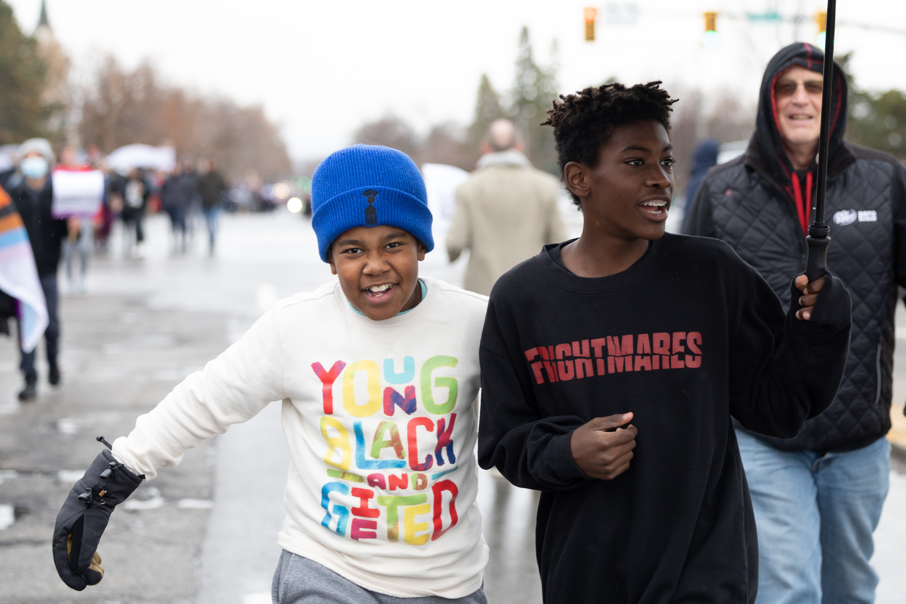 Amari Uttah, left, and Evan Mckillip, right, run during a Martin Luther King Jr. Day rally in Salt Lake City on Jan. 16, 2023. The University of Utah is hosting a march on Monday at East High School in Salt Lake City.