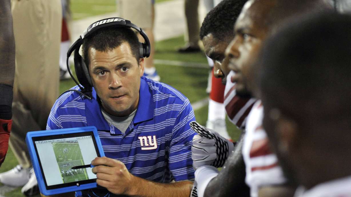 New York Giants tight ends coach Kevin Gilbride uses a Microsoft Surface tablet at the Pro Football Hall of Fame exhibition NFL football game against the Buffalo Bills Sunday, Aug. 3, 2014, in Canton, Ohio.