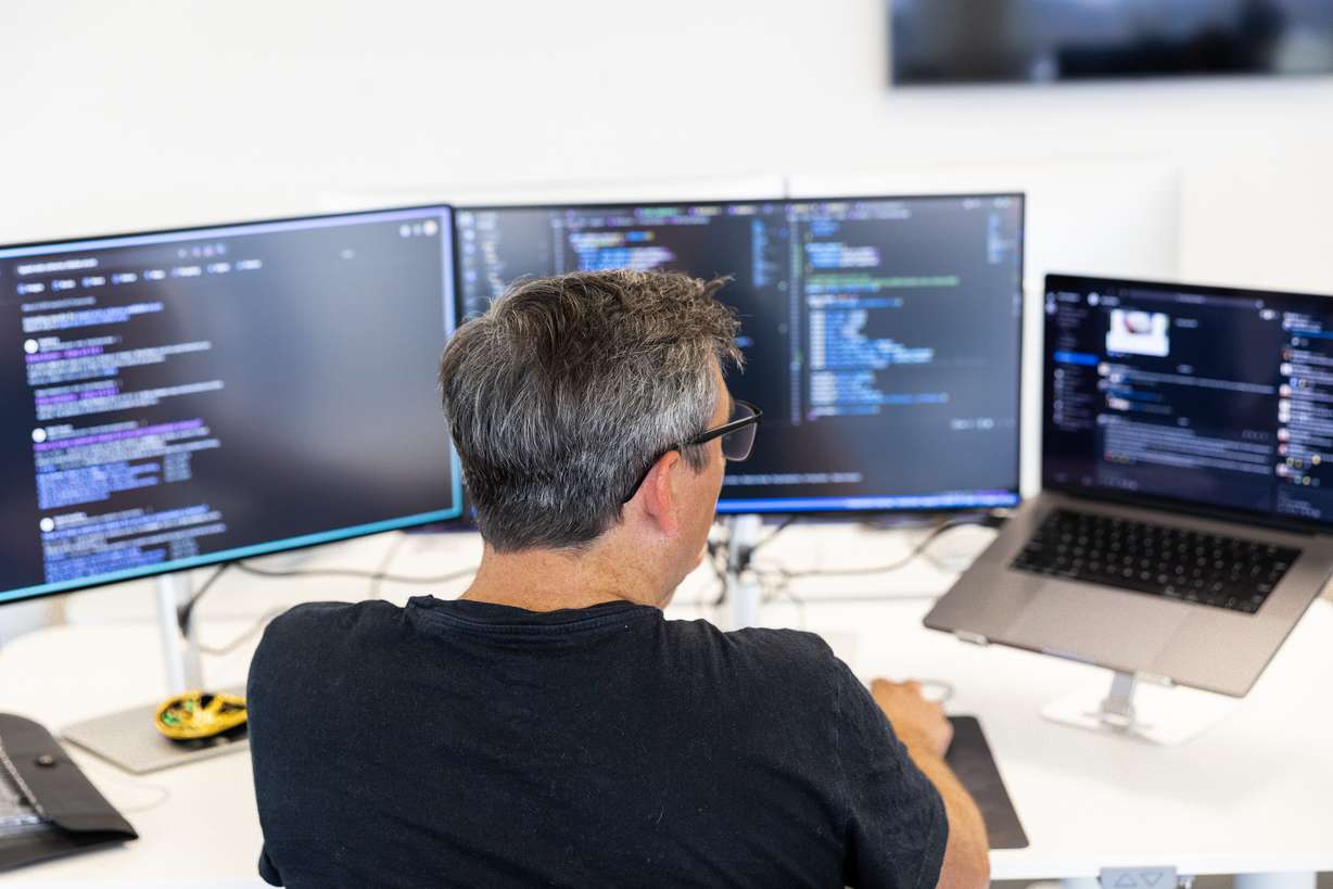 Stephen Hogan, senior engineer at Crew, in Lehi, works on their application to provide a family-focused banking experience.