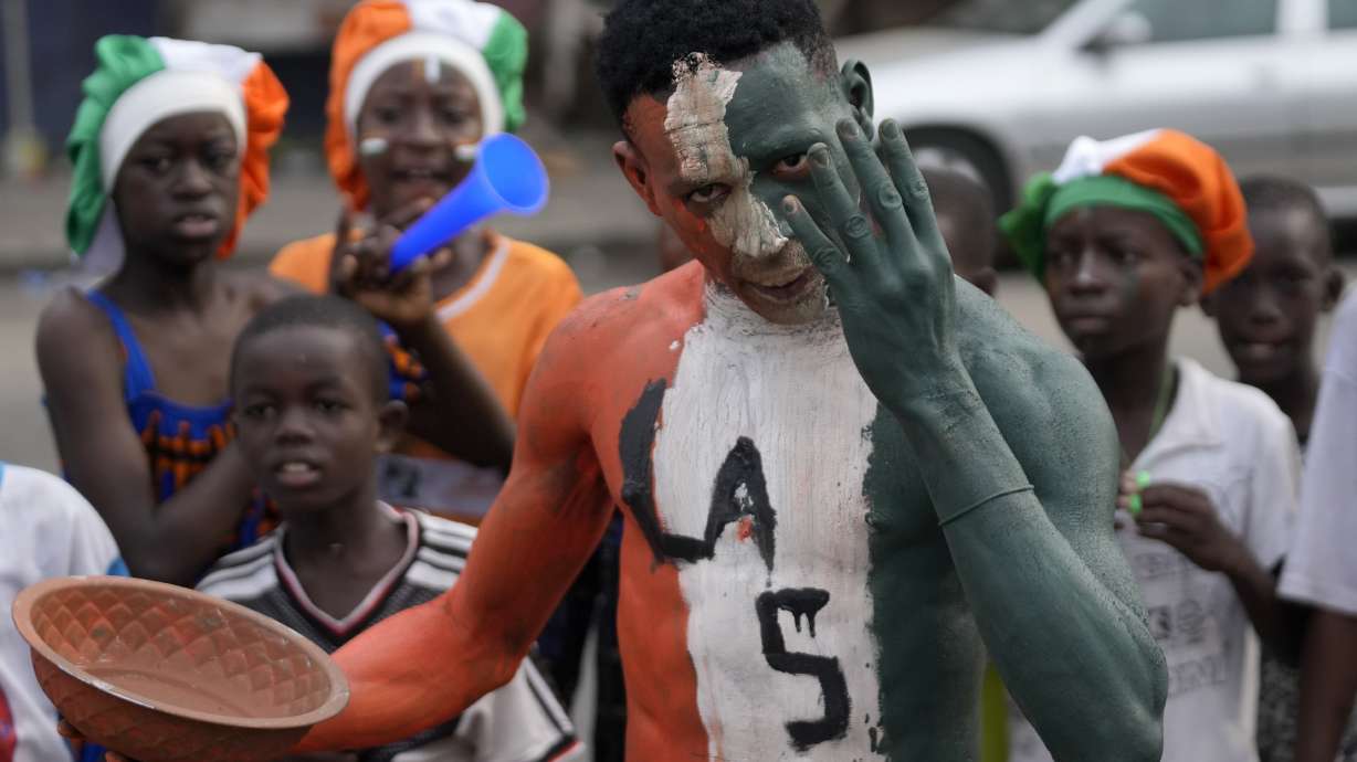 Ivorians sing and dance on the street ahead of the African Cup of Nations Group A soccer match between Ivory Coast and Guinea-Bissau in Abidjan, Ivory Coast, Saturday, Jan. 13, 2024.