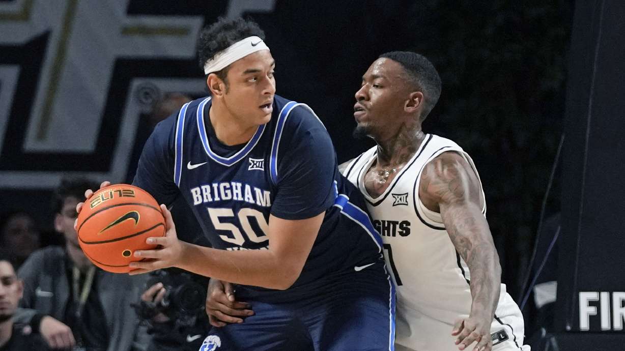 BYU center Aly Khalifa (50) looks fro a way around Central Florida forward C.J. Walker during the first half of an NCAA college basketball game, Saturday, Jan. 13, 2024, in Orlando, Fla.