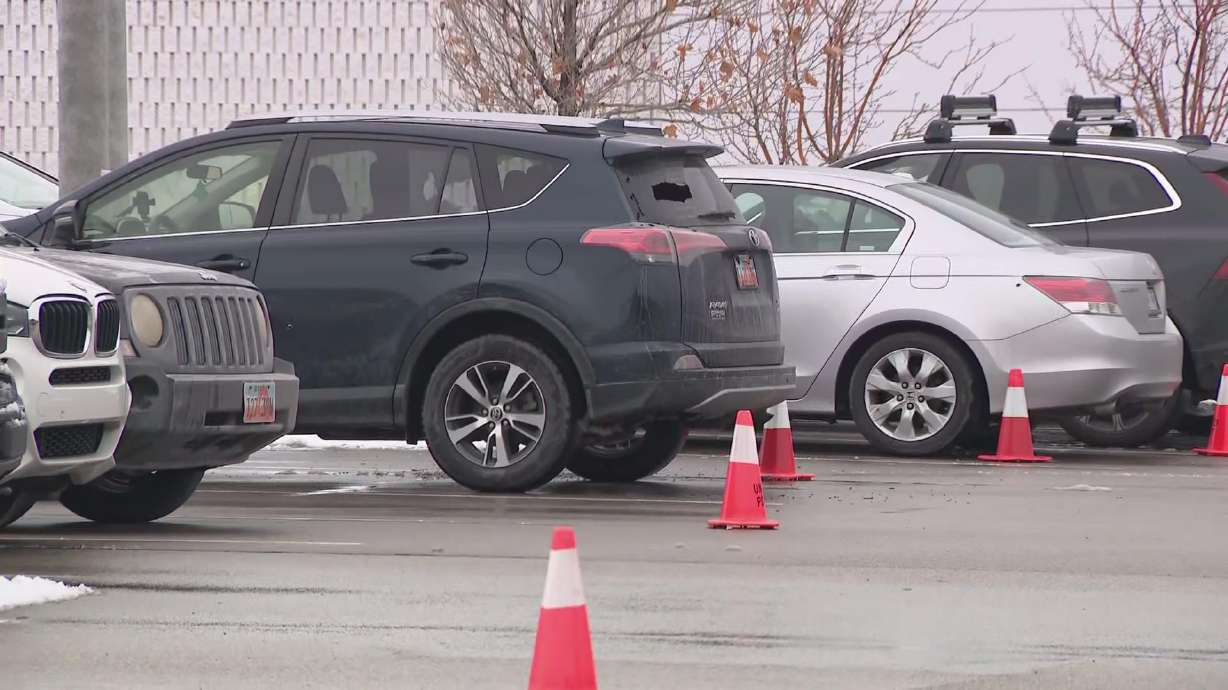 A vehicle in the parking lot at Fashion Place Mall in Murray shows damage sustained when shots were fired during an argument there on Jan. 13. Two more men were charged Monday and accused of participating in that shootout.