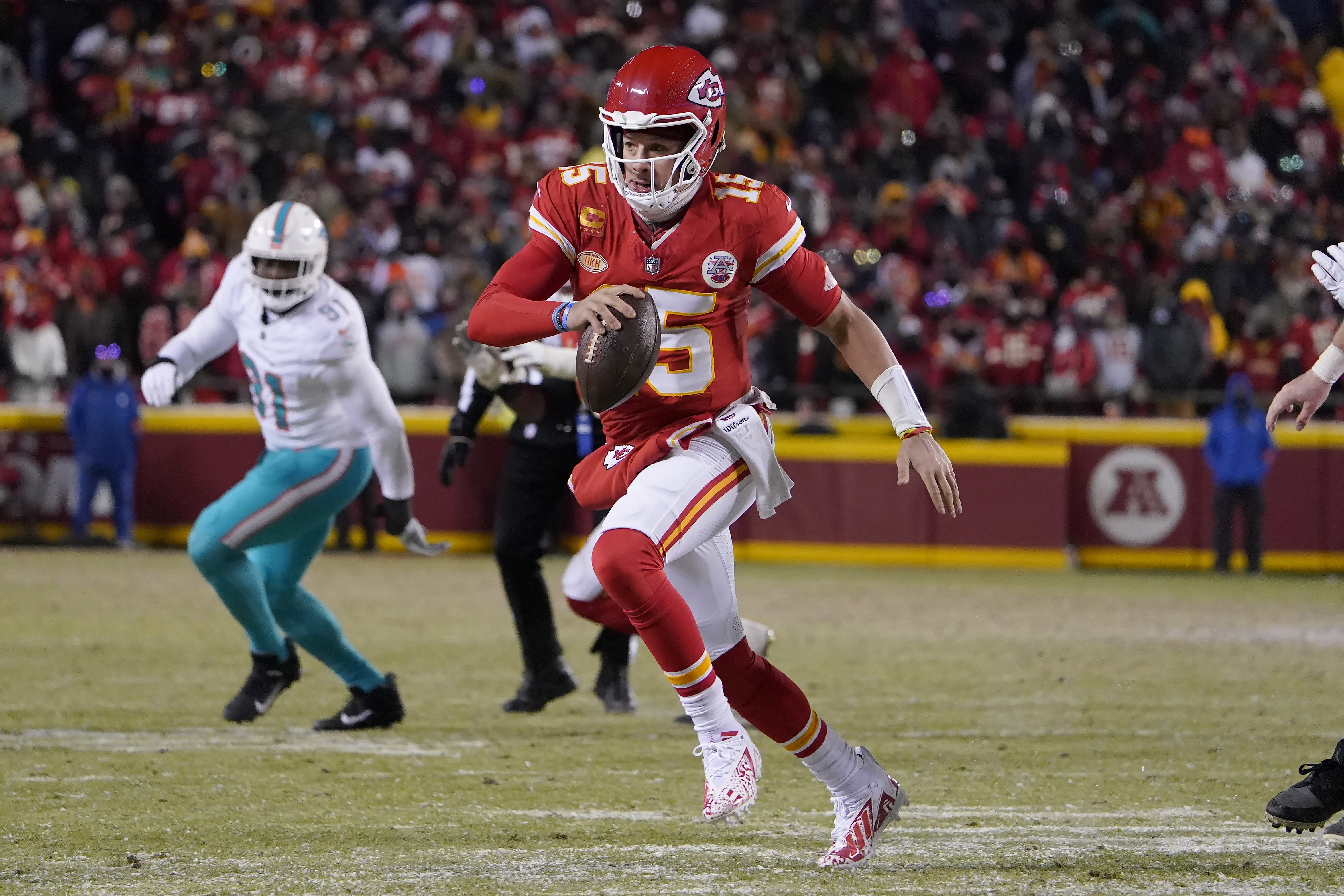 Kansas City Chiefs quarterback Patrick Mahomes (15) runs against the Miami Dolphins during the second half of an NFL wild-card playoff football game Saturday, Jan. 13, 2024, in Kansas City, Mo. 