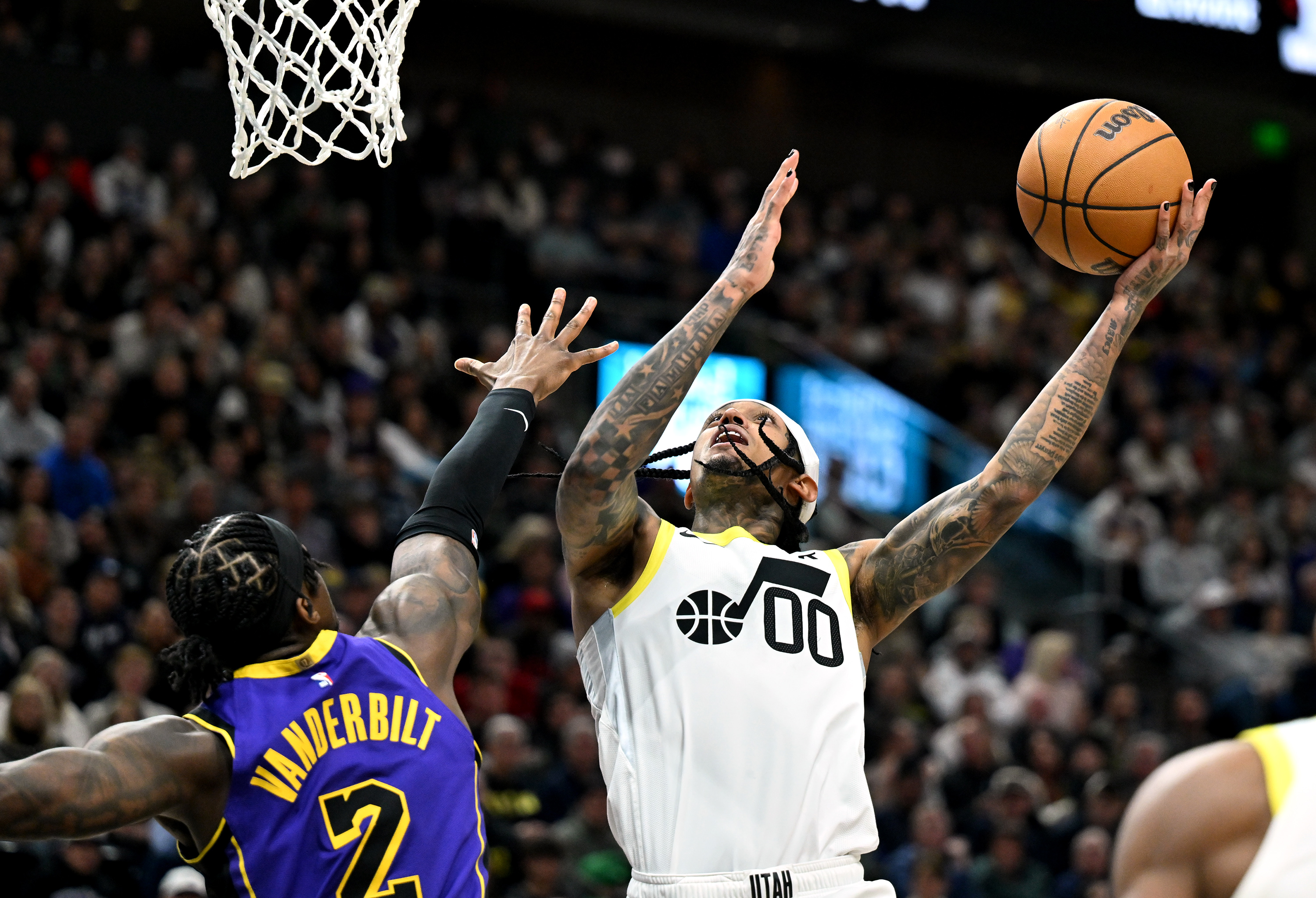 Utah Jazz guard Jordan Clarkson (00) flips up a shot over Los Angeles Lakers forward Jarred Vanderbilt (2) as Utah and Los Angeles play at the Delta Center in Salt Lake City on Saturday, Jan. 13, 2024.