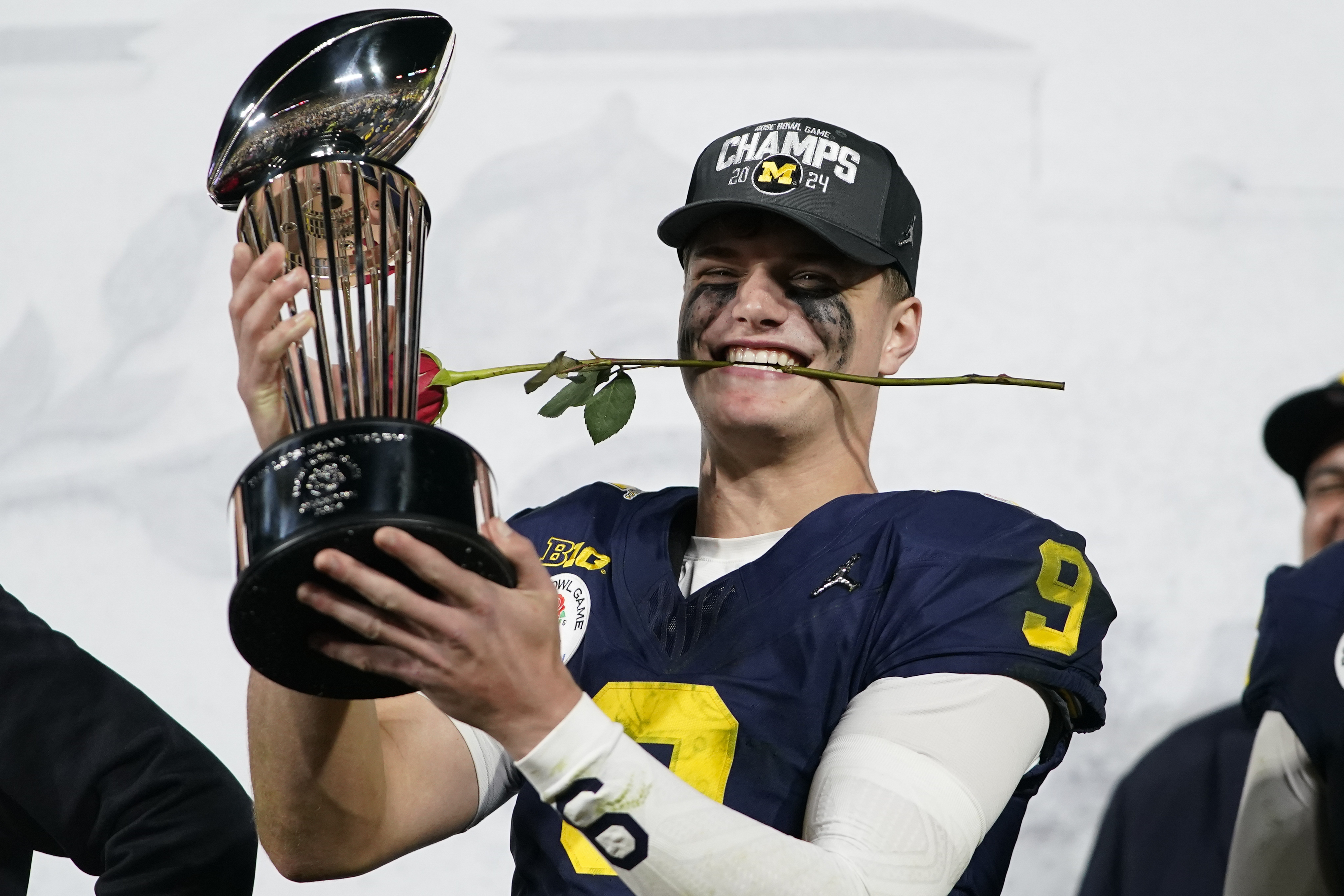 Michigan quarterback J.J. McCarthy (9) celebrates on the podium after a win over Alabama in the Rose Bowl CFP NCAA semifinal college football game Monday, Jan. 1, 2024, in Pasadena, Calif.