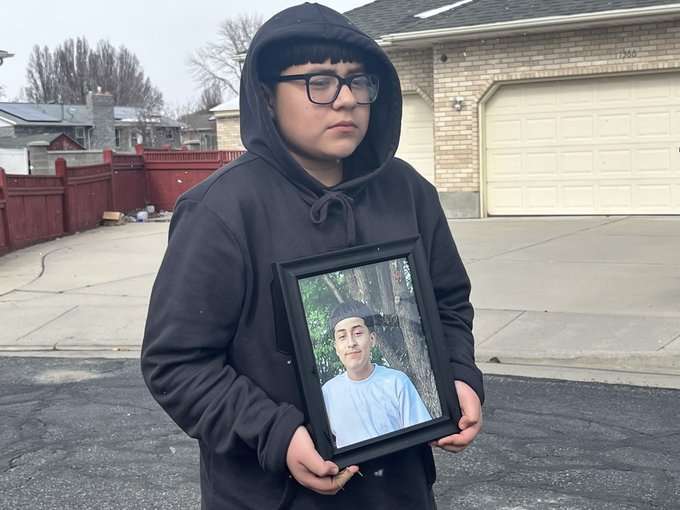 A younger brother of Francisco Jesus Cuena holds a photo of his slain brother.