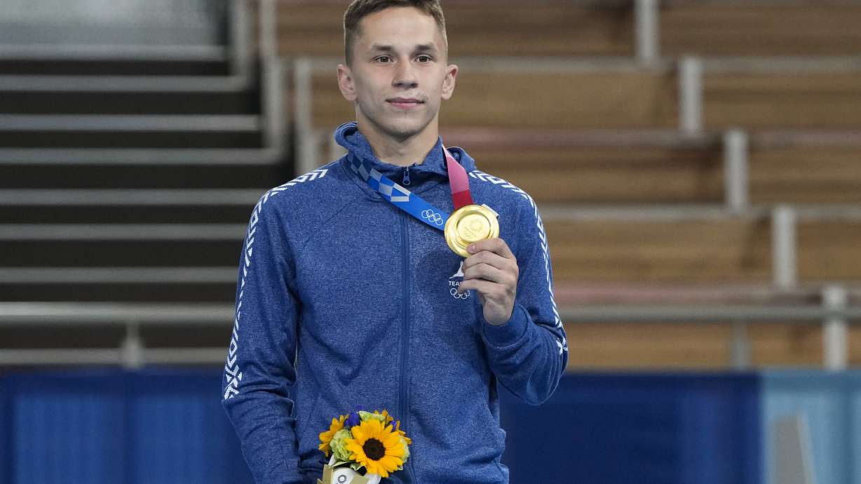 FILE - Gold medallist Ivan Litvinovich, of Belarus, poses for a photo during a medal ceremony after men's trampoline gymnastics at the 2020 Summer Olympics, on July 31, 2021, in Tokyo. The International Gymnastics Federation said Monday Jan. 15, 2024 it gave neutral status for competitions to 30 athletes and officials from Belarus though it is unclear how any could still qualify for the Paris Olympics. The only Belarusian gold medalist at the Tokyo Olympics, trampoline gymnast Ivan Litvinovich, is on the FIG list of approved people who could return to international competitions during the military invasion of Ukraine by Russia which Belarus supports.