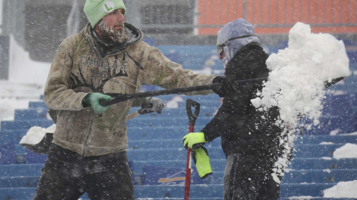 Workers remove snow from Highmark Stadium in Orchard Park, N.Y., Sunday Jan. 14, 2024. A potentially dangerous snowstorm that hit the Buffalo region on Saturday led the NFL to push back the Bills wild-card playoff game against the Pittsburgh Steelers from Sunday to Monday. New York Gov. Kathy Hochul and the NFL cited public safety concerns for the postponement, with up to 2 feet of snow projected to fall on the region over a 24- plus hour period.