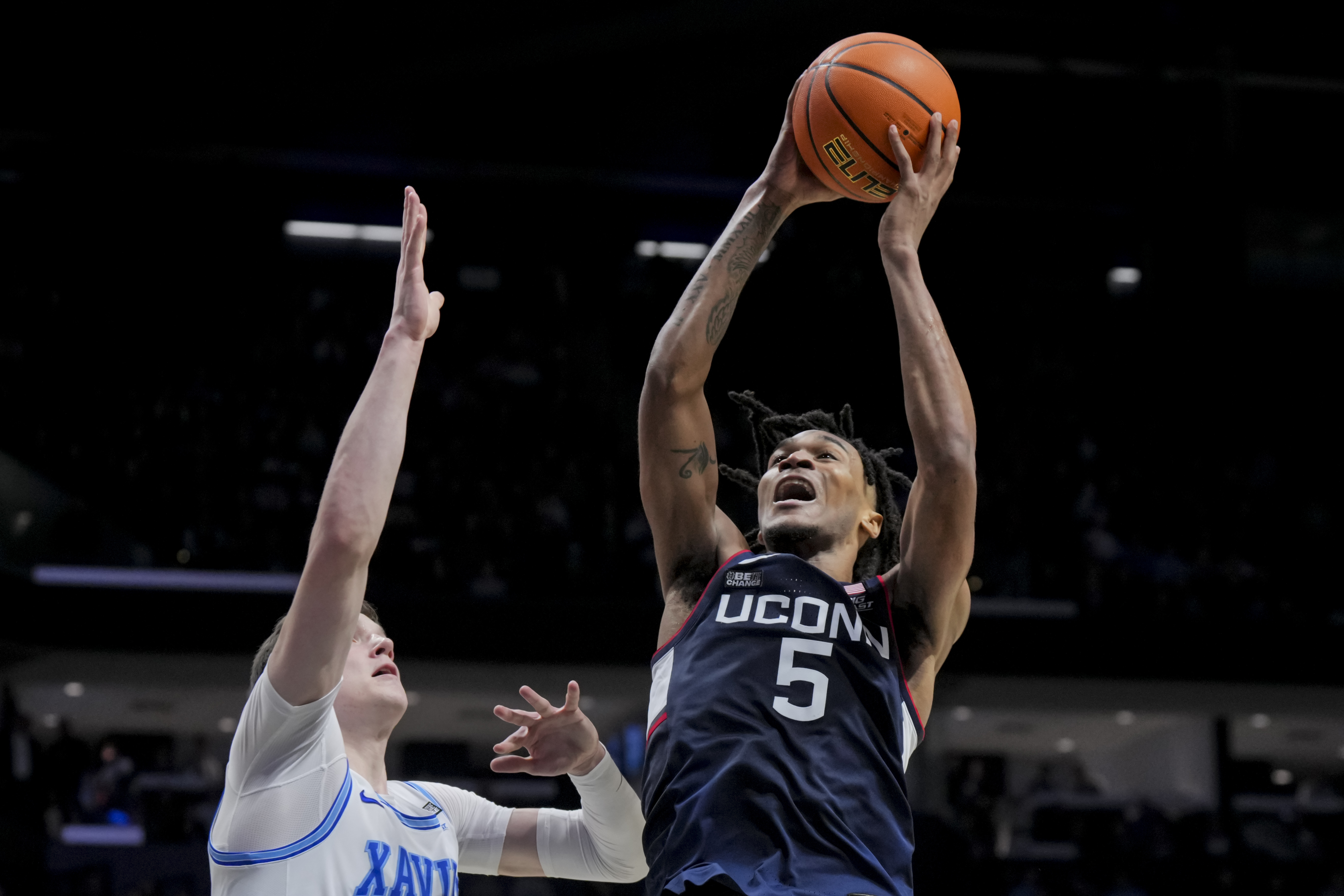 UConn guard Stephon Castle (5) drives to the basket against Xavier's forward Lazar Djokovic during the second half of an NCAA college basketball game Wednesday, Jan. 10, 2024, in Cincinnati. 