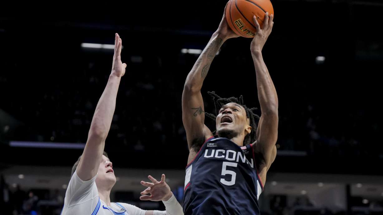 UConn guard Stephon Castle (5) drives to the basket against Xavier's forward Lazar Djokovic during the second half of an NCAA college basketball game Wednesday, Jan. 10, 2024, in Cincinnati.