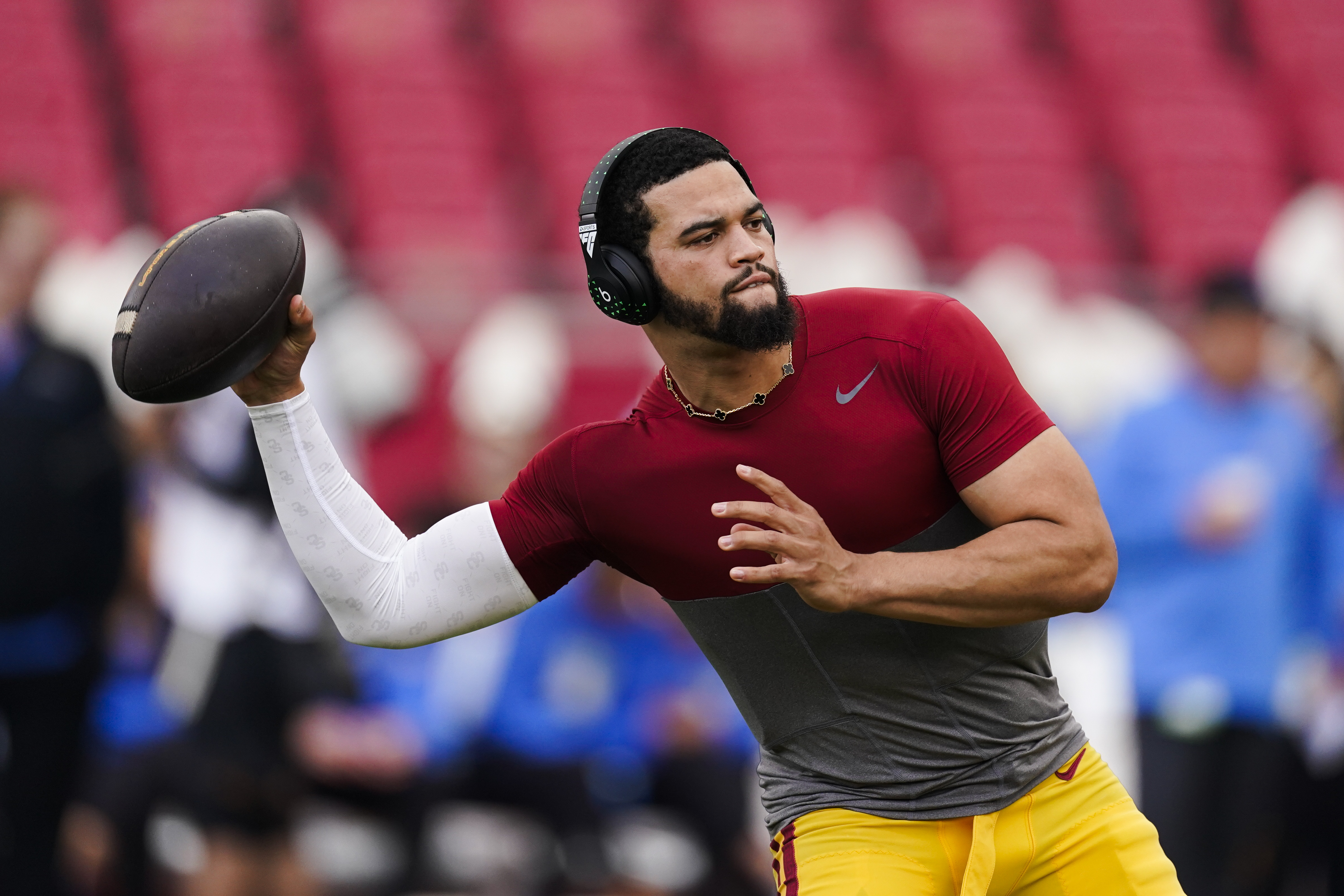 FILE - Southern California quarterback Caleb Williams warms up for the team's NCAA college football game against UCLA, Nov. 18, 2023, in Los Angeles. USC will play its final game as a member of the Pac-12 Conference before moving to the Big Ten next season. Williams, the 2022 Heisman Trophy winner, has opted out, one of many players from both schools who will miss the game due to opting out or entering the transfer portal. 