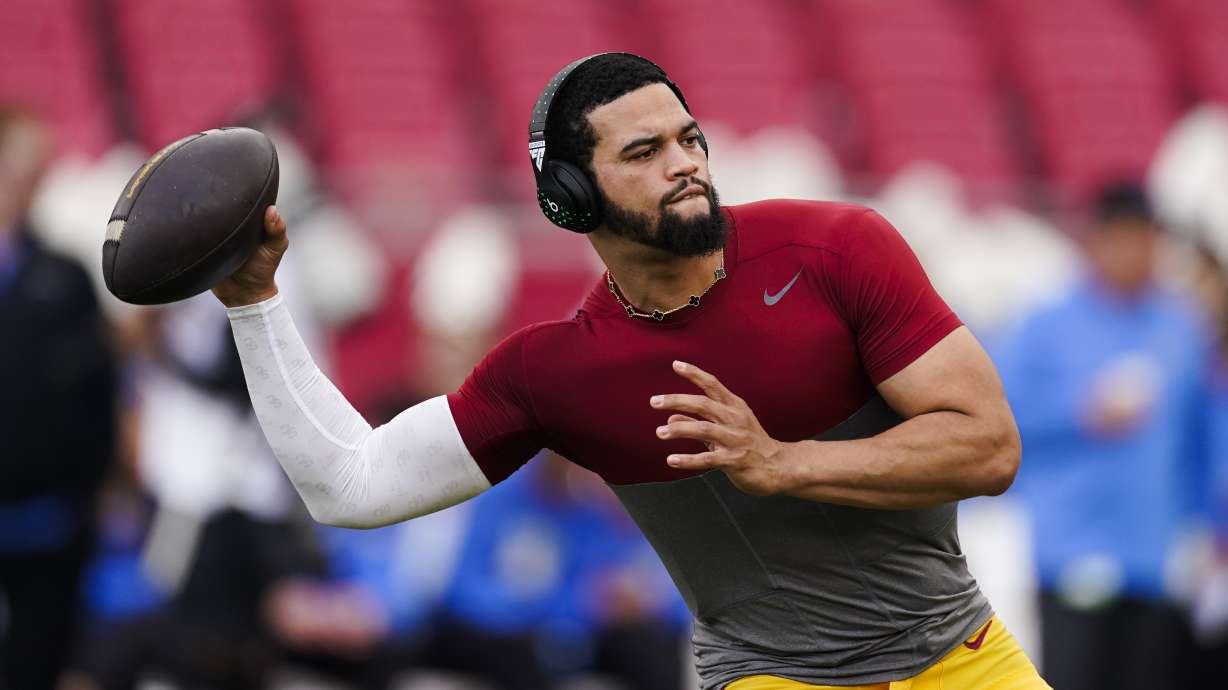 FILE - Southern California quarterback Caleb Williams warms up for the team's NCAA college football game against UCLA, Nov. 18, 2023, in Los Angeles. USC will play its final game as a member of the Pac-12 Conference before moving to the Big Ten next season. Williams, the 2022 Heisman Trophy winner, has opted out, one of many players from both schools who will miss the game due to opting out or entering the transfer portal.