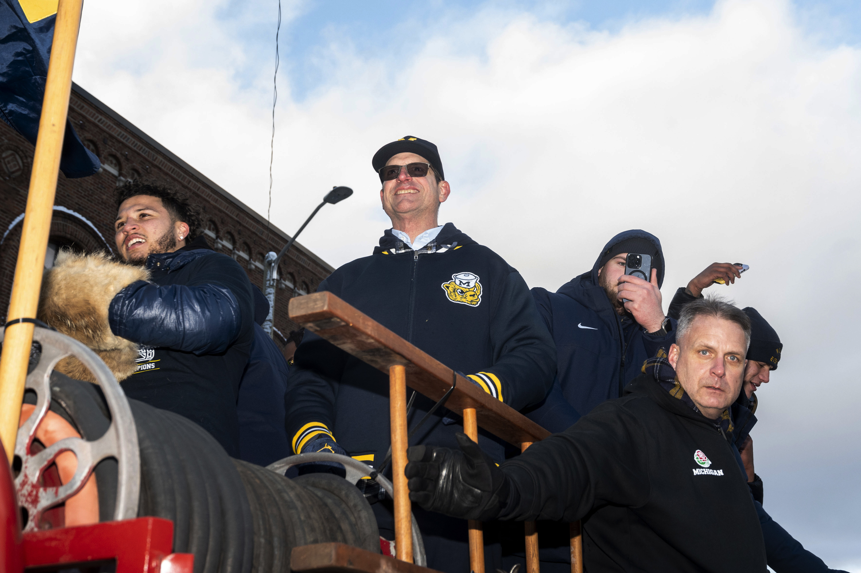Michigan running back Blake Corum, coach Jim Harbaugh and offensive lineman Zak Zinter take part in a parade celebrating Michigan's college football title, in Ann Arbor, Mich., Saturday, Jan. 13, 2024. 