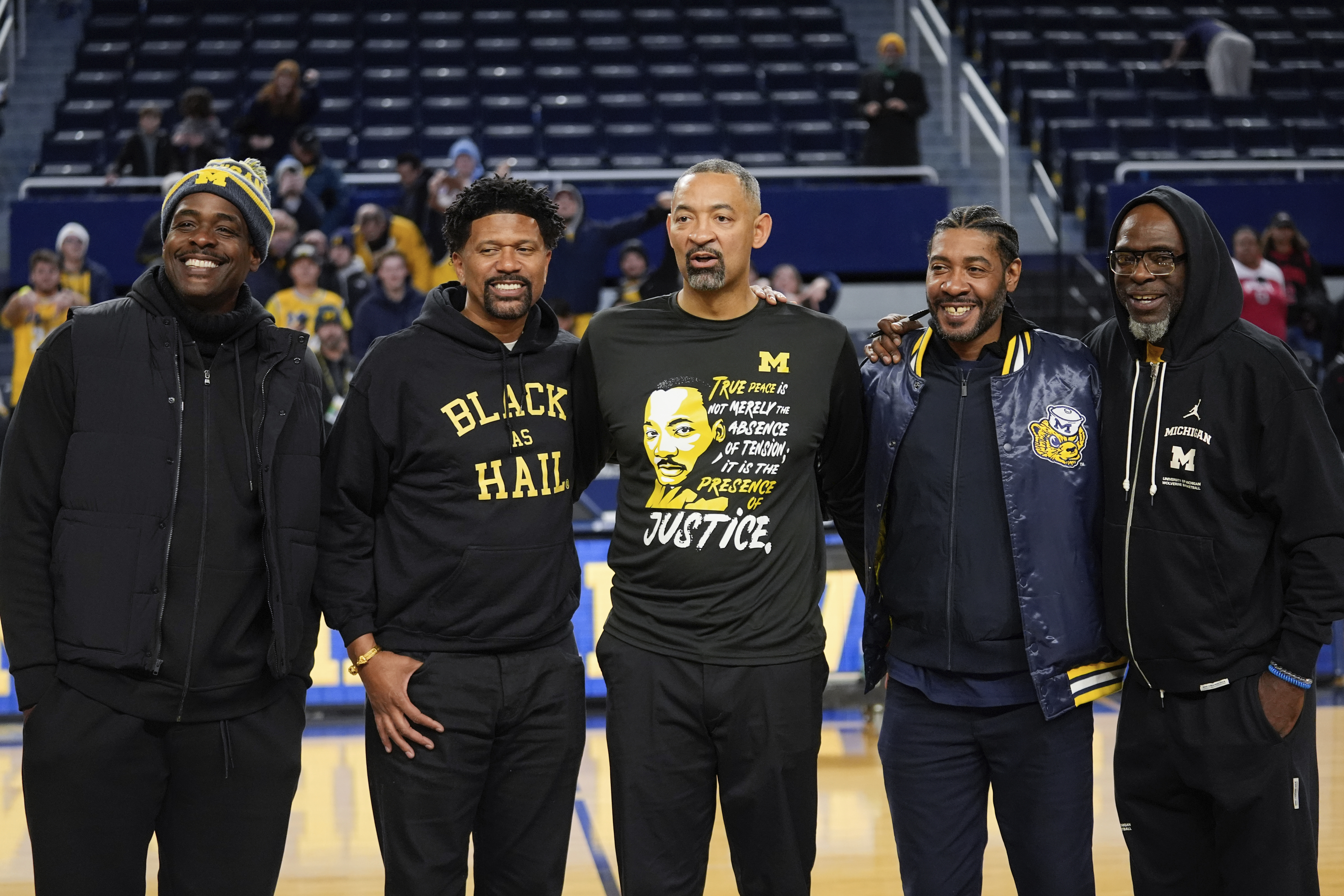 Former Michigan Fab Five basketball players Chris Webber, from left, Jalen Rose, Michigan head coach Juwan Howard, Jimmy King and Ray Jackson pose pose after an NCAA college basketball game against Ohio State in Ann Arbor, Mich., Monday, Jan. 15, 2024. 