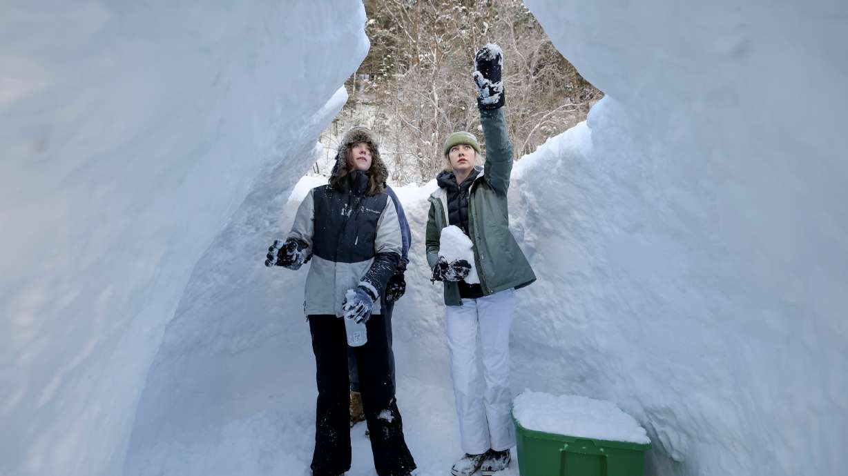 Kathryn Watkins and Annabella Schweitz build an igloo by the Mill B trailhead in Big Cottonwood Canyon on Monday. Experts say Utah's snowpack was starting to look "bleak," but it looks much better after a "season-saving storm cycle."