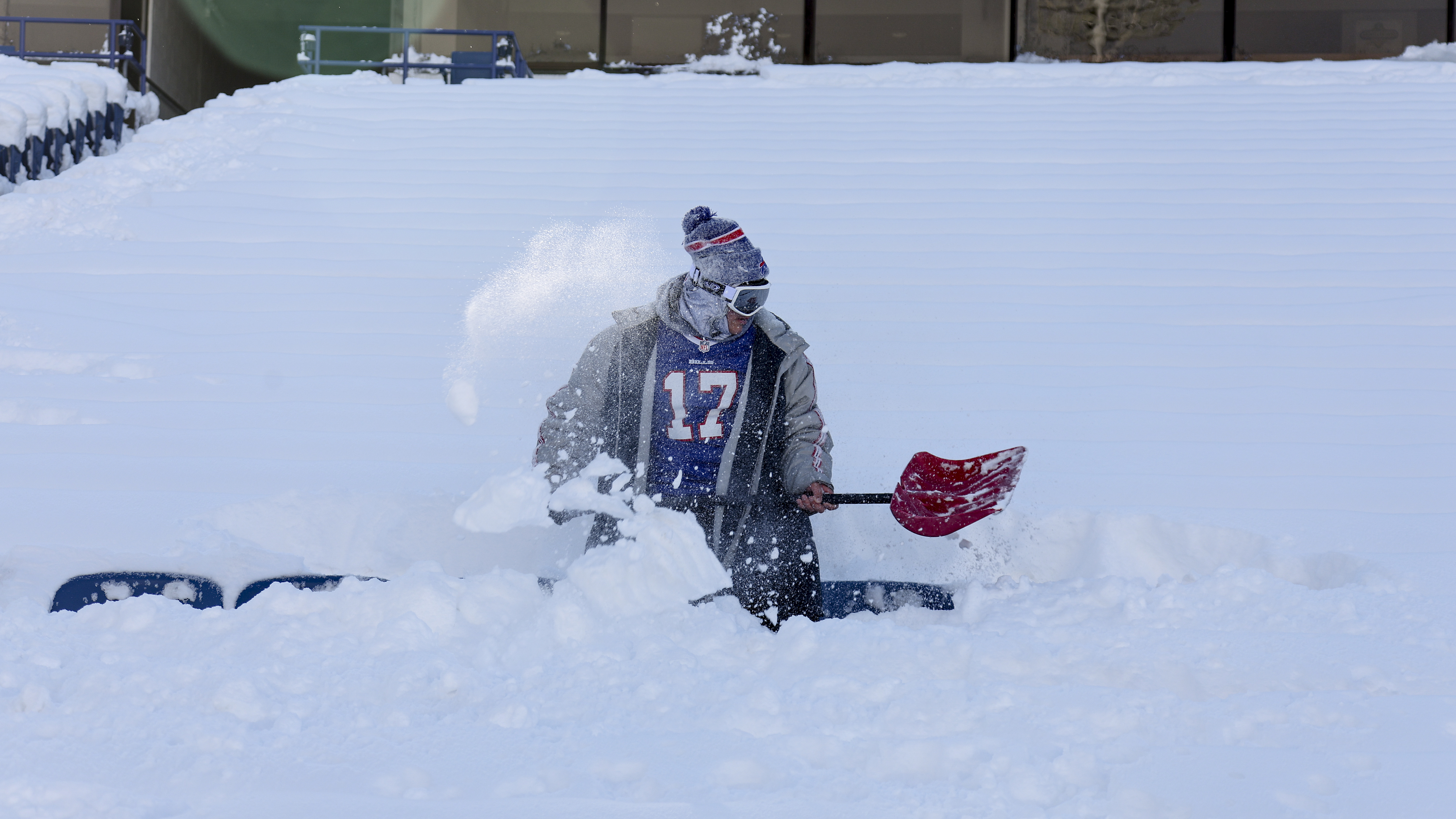 A Buffalo Bills fan clears snow from his row of seats before an NFL wild-card playoff football game between the Buffalo Bills and the Pittsburgh Steelers, Monday, Jan. 15, 2024, in Buffalo, N.Y. 