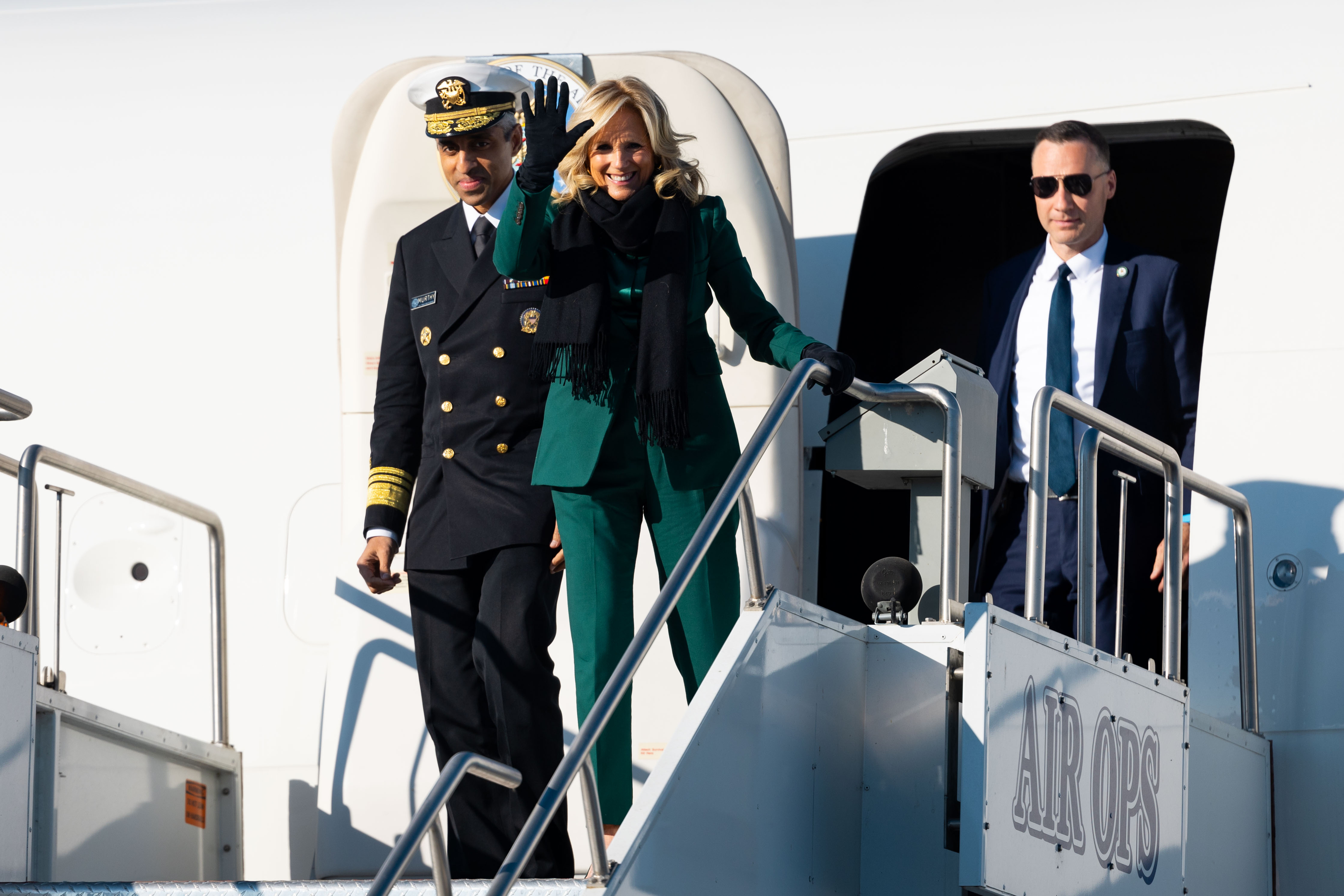 First lady Jill Biden waves upon her arrival with U.S. Surgeon General Dr. Vivek H. Murthy at Signature Aviation SLC in Salt Lake City on Tuesday.