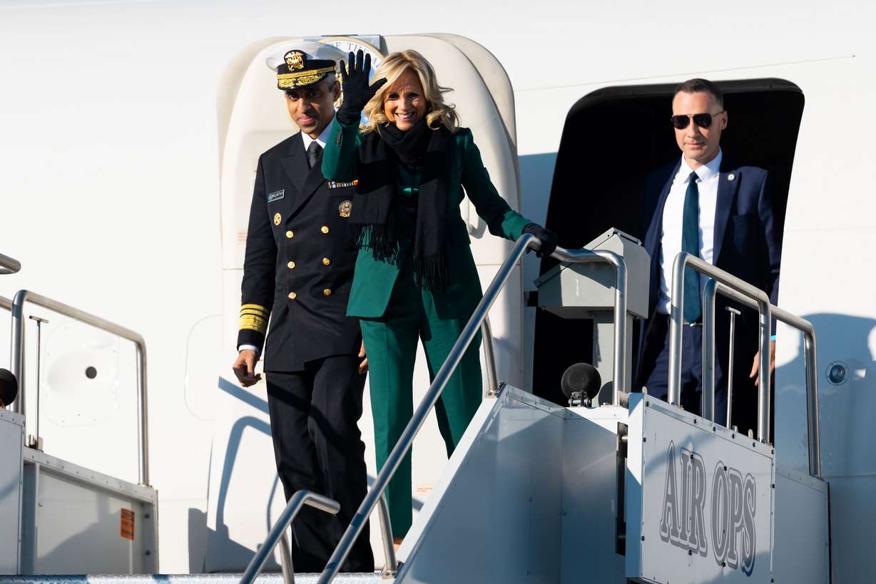 First lady Jill Biden waves upon her arrival with U.S. Surgeon General Dr. Vivek H. Murthy at Signature Aviation SLC in Salt Lake City on Tuesday.