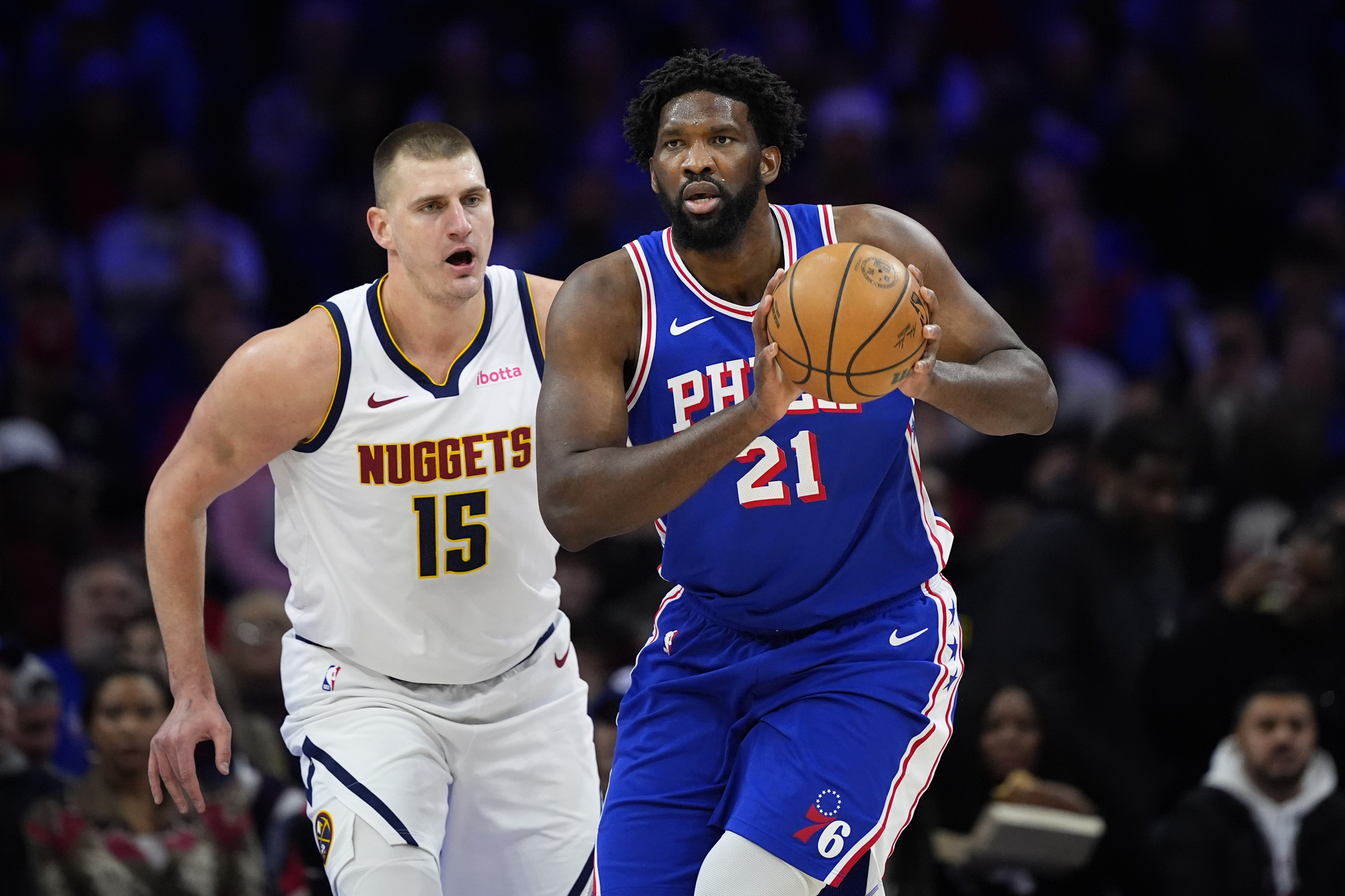 Philadelphia 76ers' Joel Embiid, right, tries to keep away from Denver Nuggets' Nikola Jokic during the first half of an NBA basketball game, Tuesday, Jan. 16, 2024, in Philadelphia. 