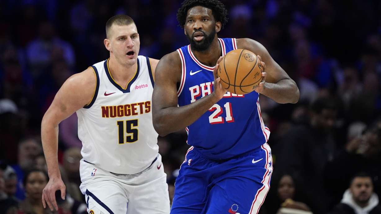 Philadelphia 76ers' Joel Embiid, right, tries to keep away from Denver Nuggets' Nikola Jokic during the first half of an NBA basketball game, Tuesday, Jan. 16, 2024, in Philadelphia.