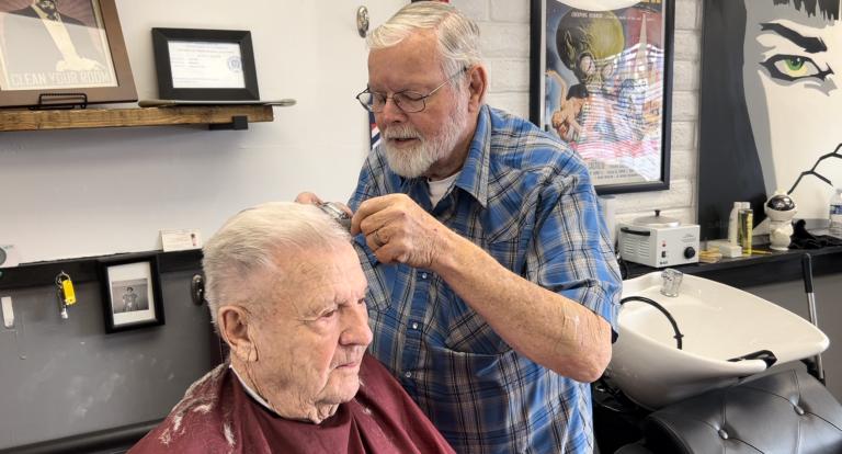 Richard Lister does his 15-minute haircut for Ross Summers on Friday.
